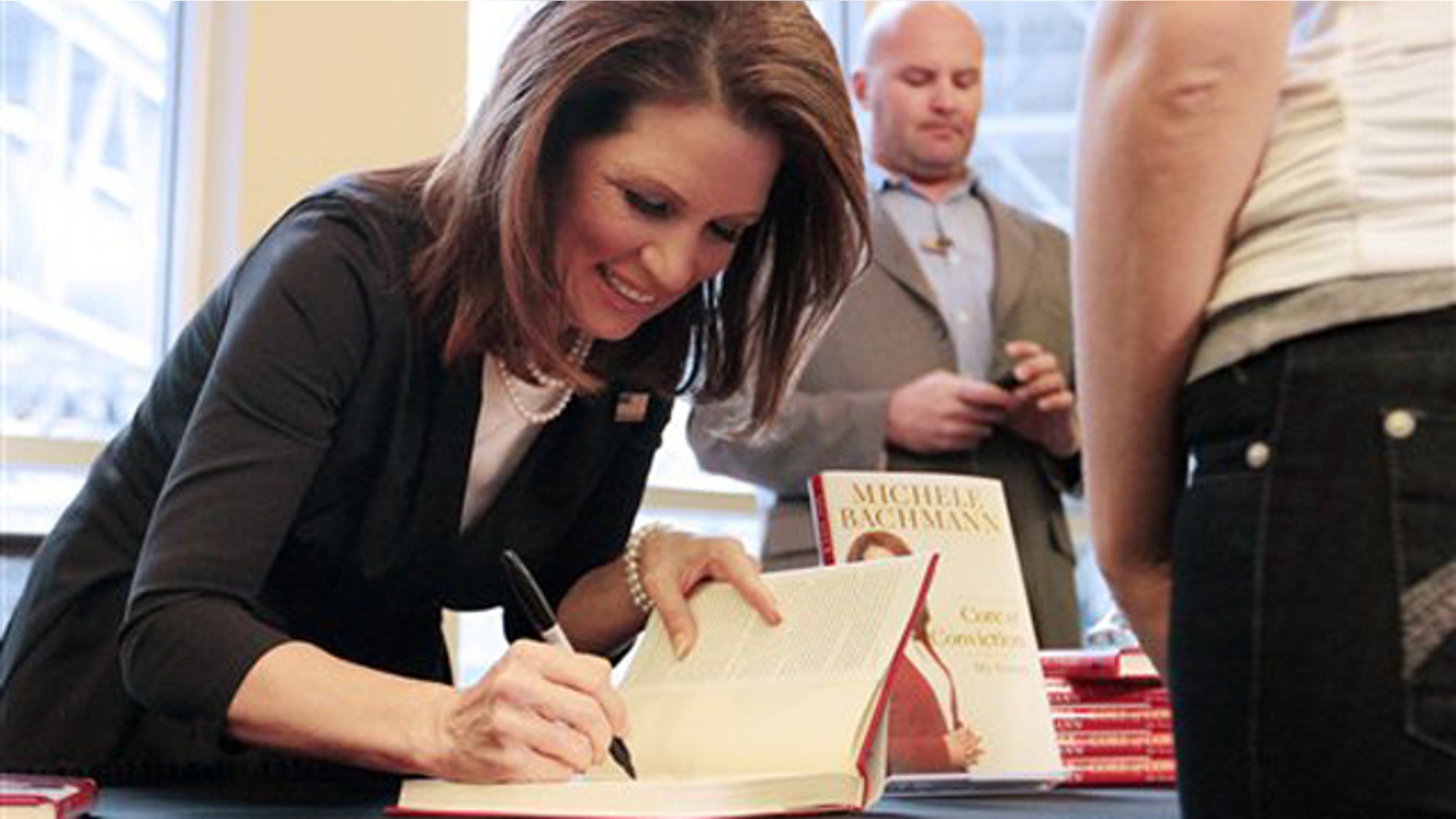 Nov. 25, 2011: Rep. Michele Bachmann signs a copy of her new book, "Core of Conviction," during a campaign stop at the Mall of America in Bloomington, Minn.