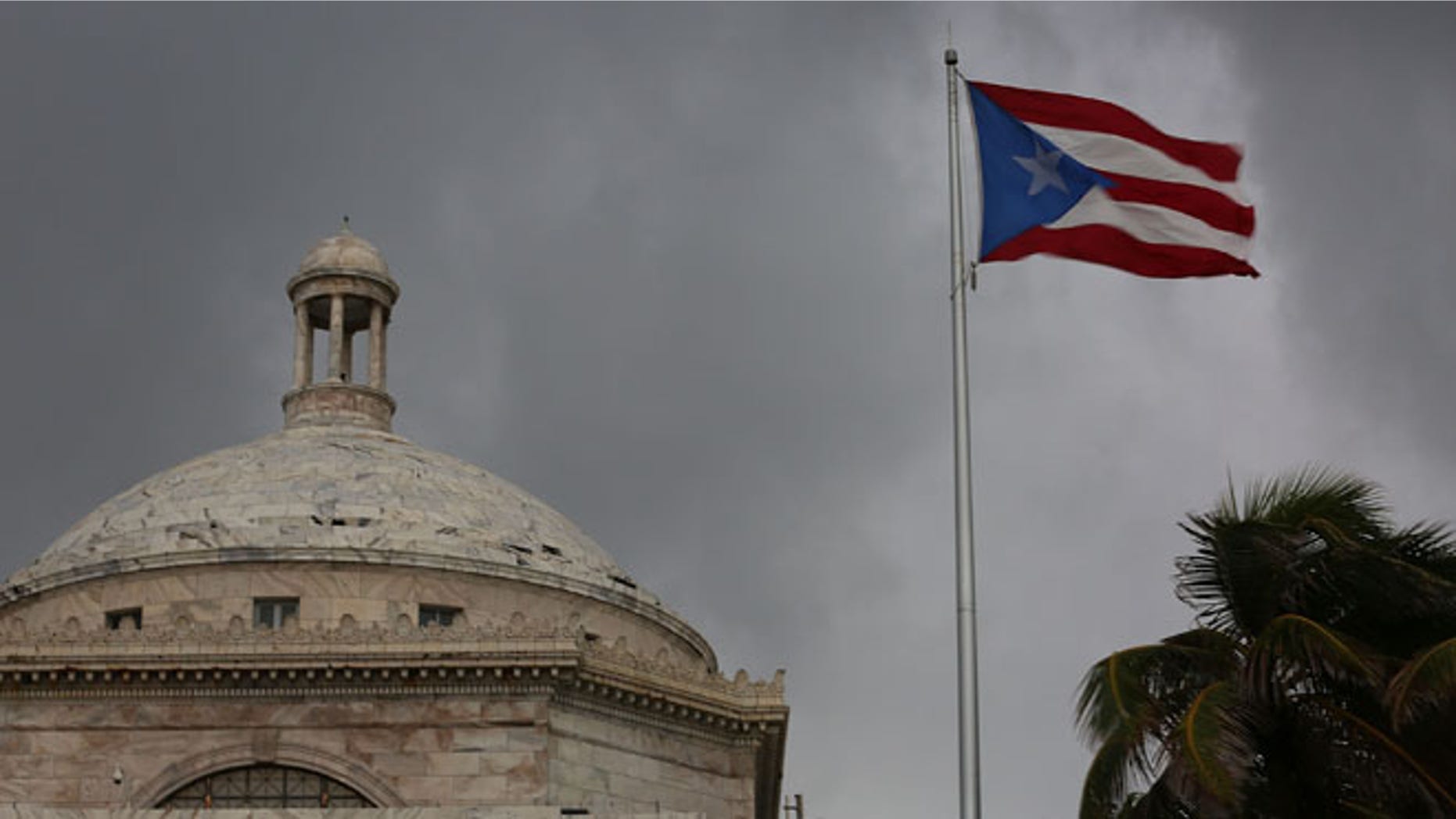 The Puerto Rican flag flies near the Capitol on July 1, 2015 in San Juan, Puerto Rico.