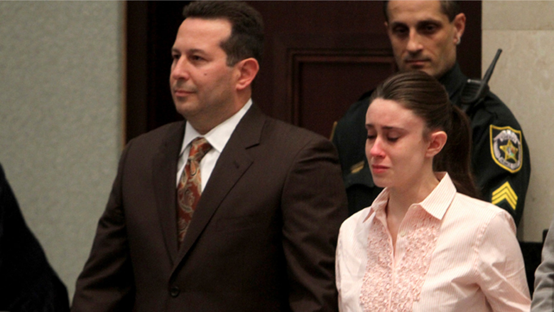July 5: Casey Anthony holds hands with her defense attorney Jose Baez as they listen to the verdict at the Orange County Courthouse.
