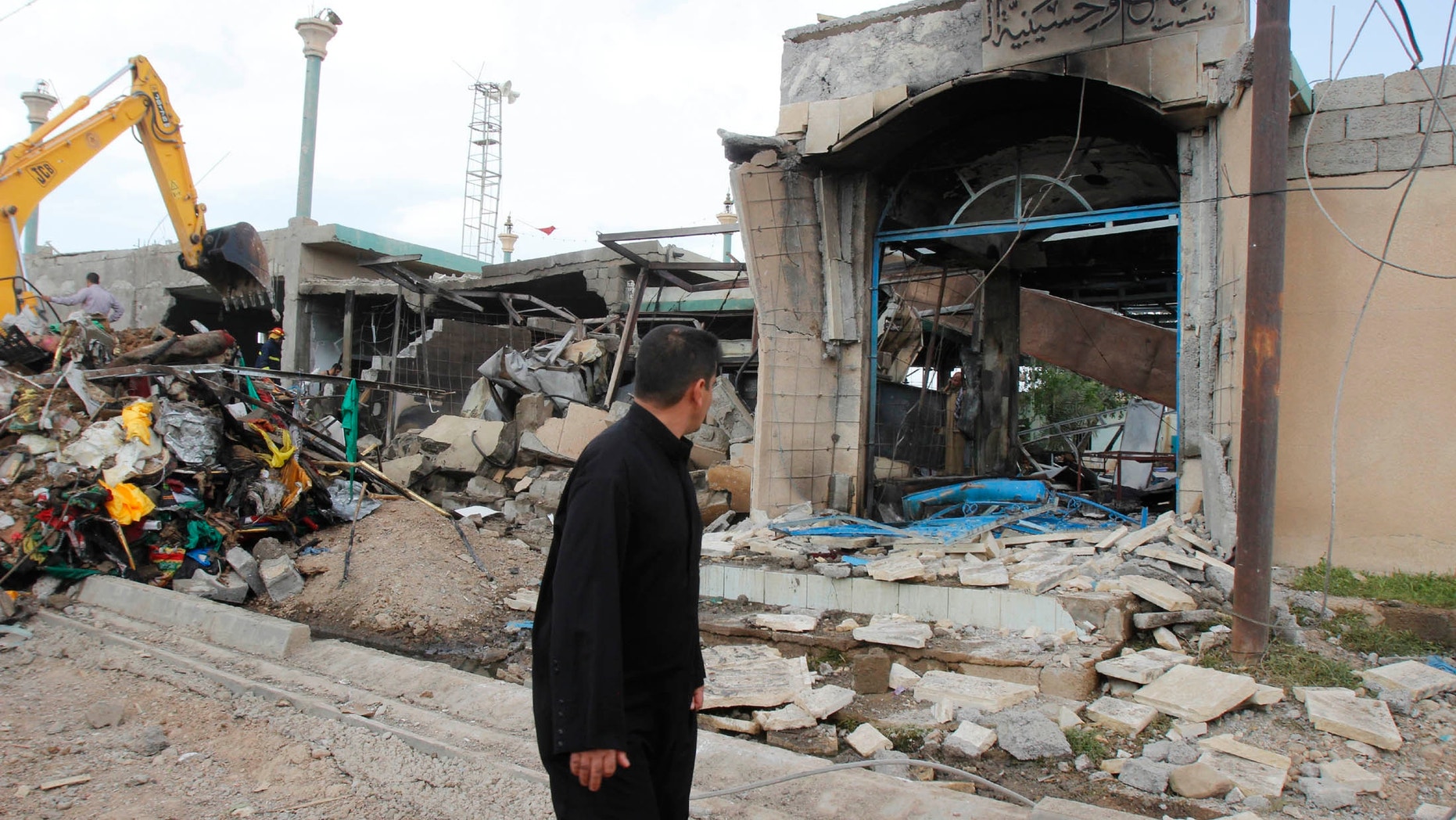 March 29, 2013 - A man looks at the site of a bomb attack in Kirkuk, 155 miles north of Baghdad.