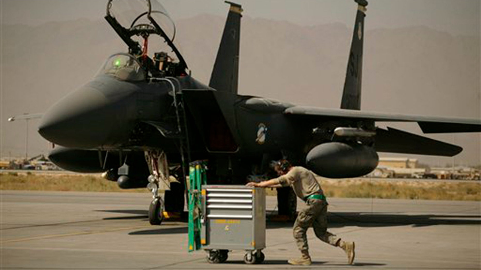 In this Oct. 17 picture, a U.S. Air Force airman passes an F-15E Strike Eagle at Bagram Air Field in Afghanistan. (AP Photo)