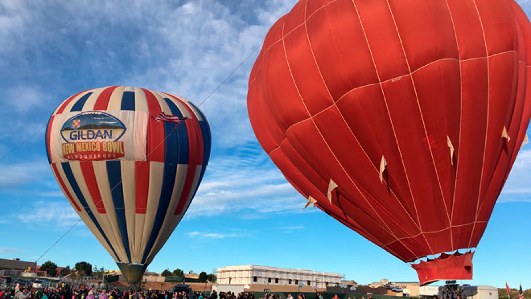 Two hot air balloons inflate at Vista Grande Elementary School in Rio Rancho, N.M. on Friday, Sept. 30, 2016.