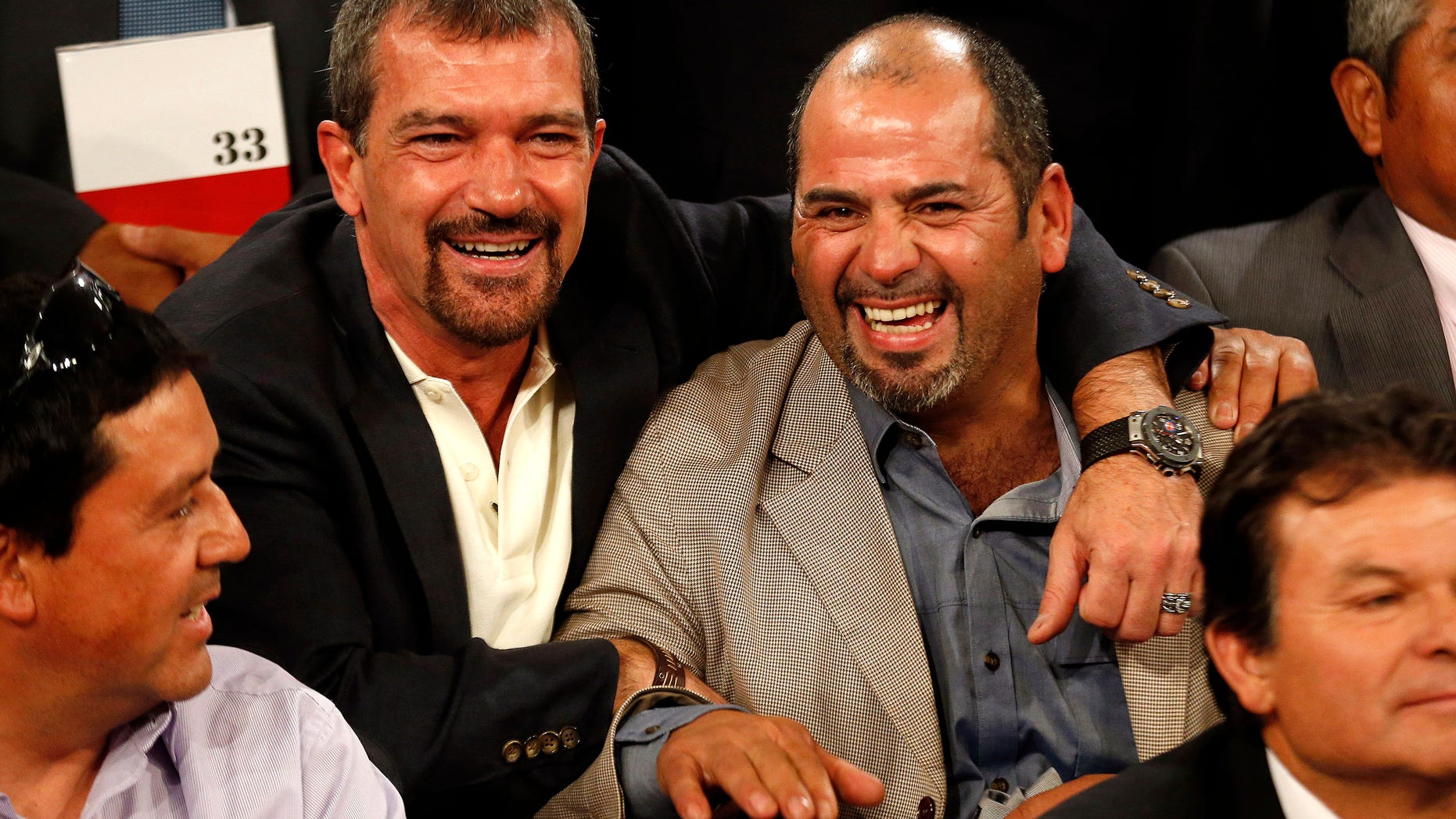 January 31, 2014. Antonio Banderas (L) poses with former miner Mario Sepulveda during an official ceremony at the presidential palace in Santiago. Banderas is in Chile to begin filming of "The 33," a film based on the true story of 33 miners who were trapped underground for some 69 days after a mining accident in 2010.