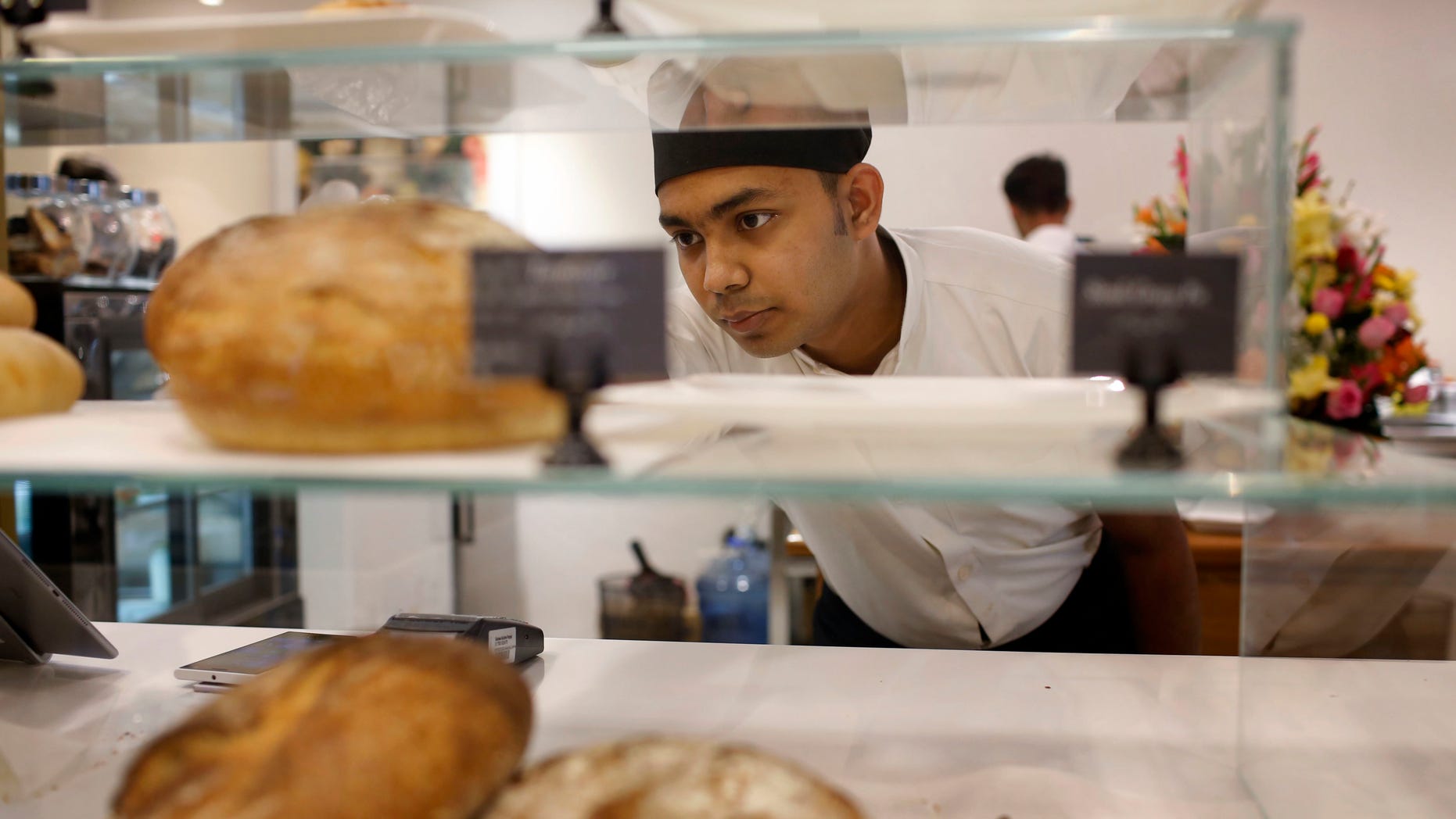 Dwin Islam Rakib, a survivor of the July 1 attack at Holey Artisan Bakery, works at the reopened restaurant in Dhaka, Bangladesh, Thursday, Jan. 12, 2017. The Bangladesh cafe besieged by militants who killed 20 hostages last year has quietly reopened in a shopping mall a few blocks from its old, bloodied site. Staff members said this week's reopening of the Holey Artisan Bakery represents a new beginning. (AP Photo)