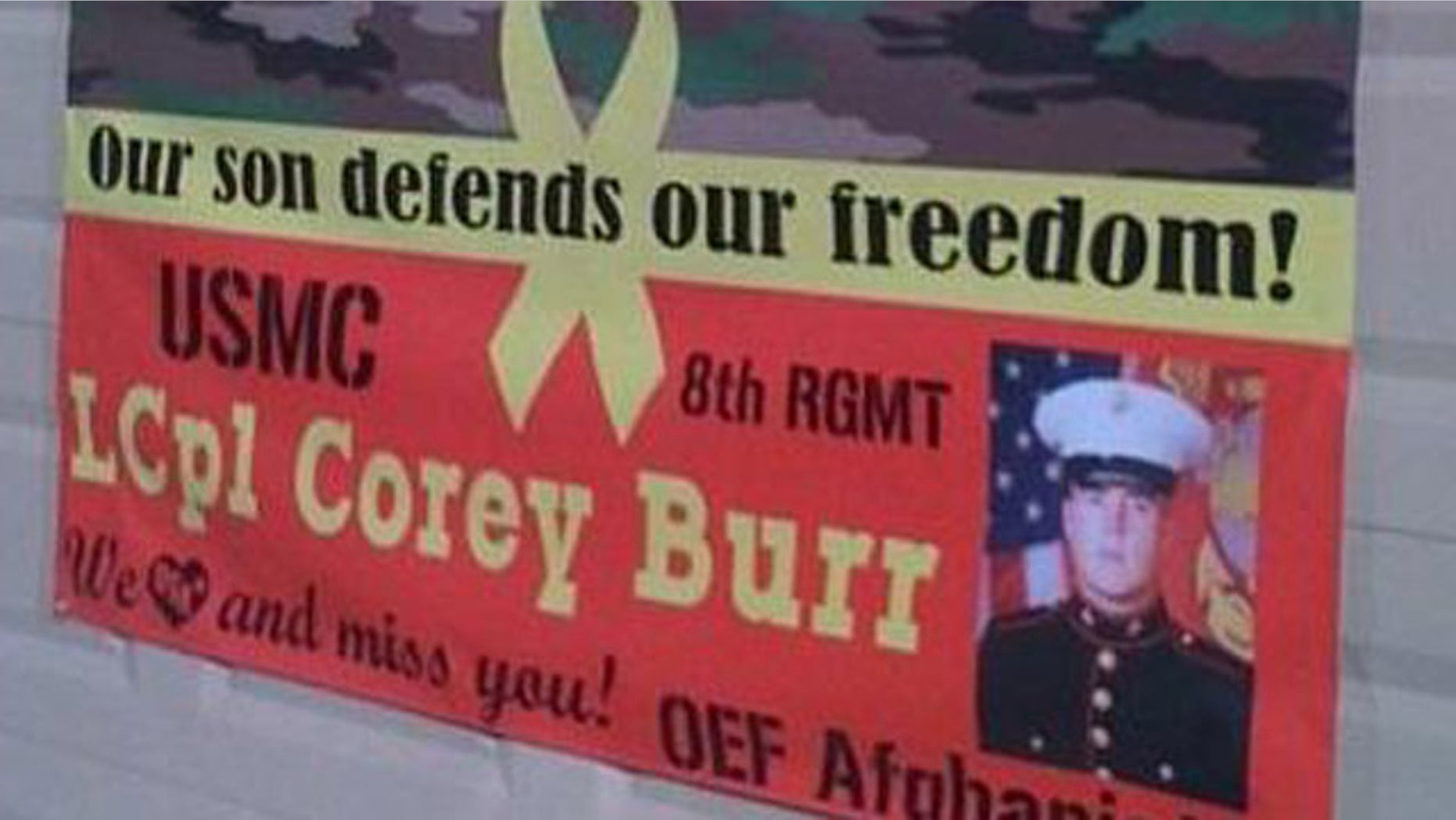 This photo, provided by Jodi Burr, shows the sign supporting their sign's military service. The Burr family says their homeowner's association is suing them for their refusal to take down the banner from their front yard.