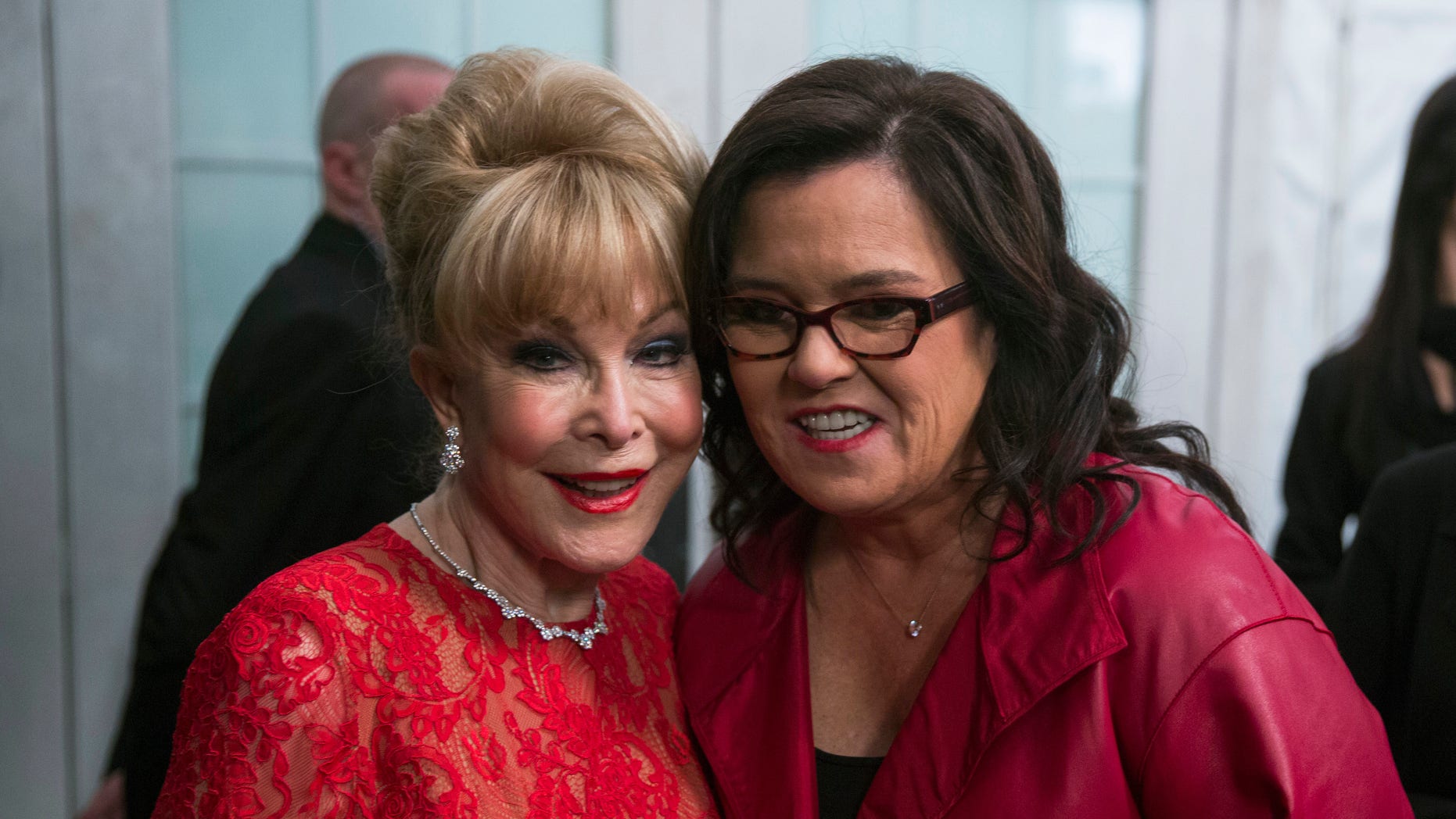 Actresses Rosie O'Donnell (R) and Barbara Eden smile for a photograph before presenting a creation from the Go Red for Women Red Dress collection during New York Fashion Week February 12, 2015. REUTERS/Lucas Jackson (UNITED STATES - Tags: FASHION SOCIETY ENTERTAINMENT) - RTR4PEDA