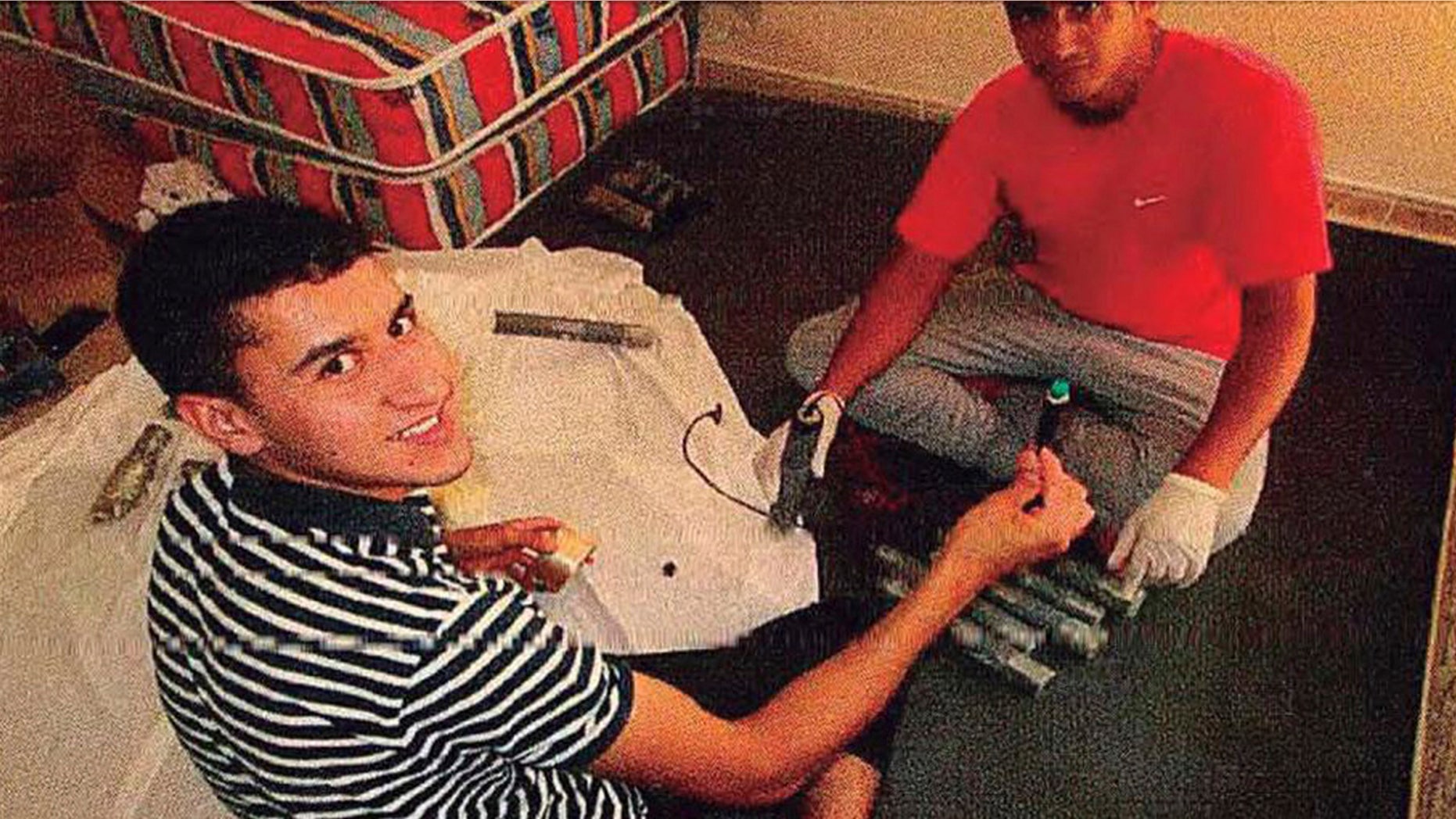 In this undated photo, published Tuesday Aug. 6, 2018 by the Spanish newspaper La Vanguardia, terrorists identified as Younes Abouyaaqoub, left, and Youssef Aalla, prepare explosives at a house in Alcanar, Spain.