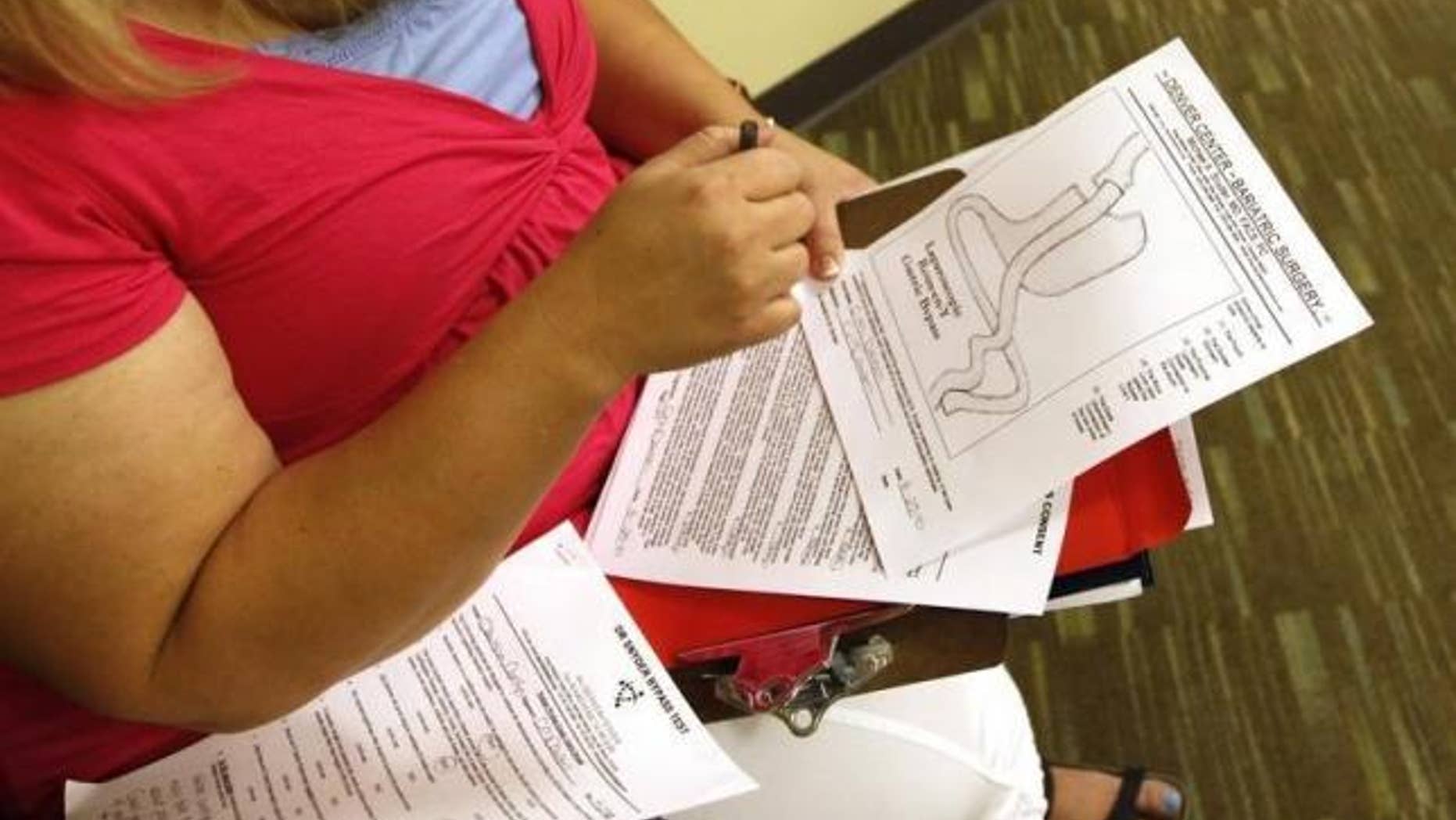 Aug. 25, 2010: A bariatric surgery patient looks at a diagram of her procedure in Denver five days before her operation.
