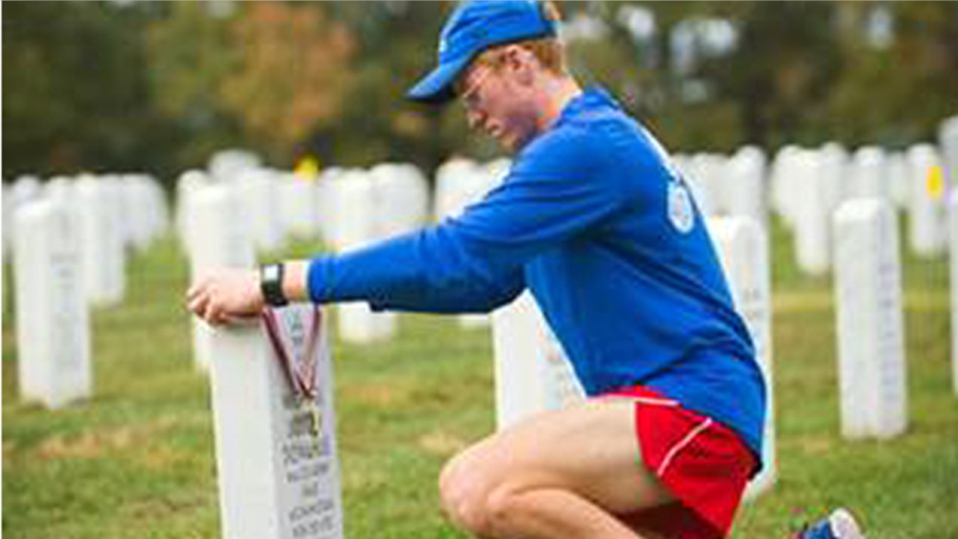 Seamus Donahue, 18, places his Marine Corps Marathon finisher’s medal on the grave of his father, Maj. Michael Donahue, at Arlington National Cemetery on Oct. 25, 2015. Seamus ran the marathon in honor of his father who was killed in Kabul, Afghanistan on Sept. 16, 2014.
