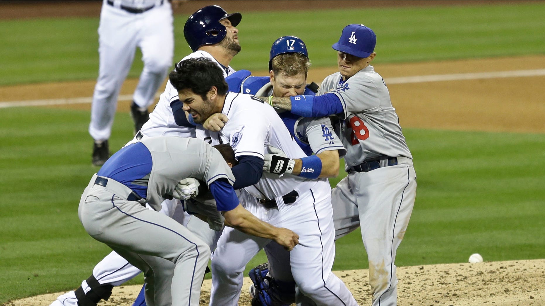 San Diego Padres' Carlos Quentin, center without hat, charges into Los Angeles Dodgers pitcher Zack Greinke, left foreground, after being hit by a pitch in the sixth inning of baseball game in San Diego, Thursday, April 11, 2013. (AP Photo/Lenny Ignelzi)
