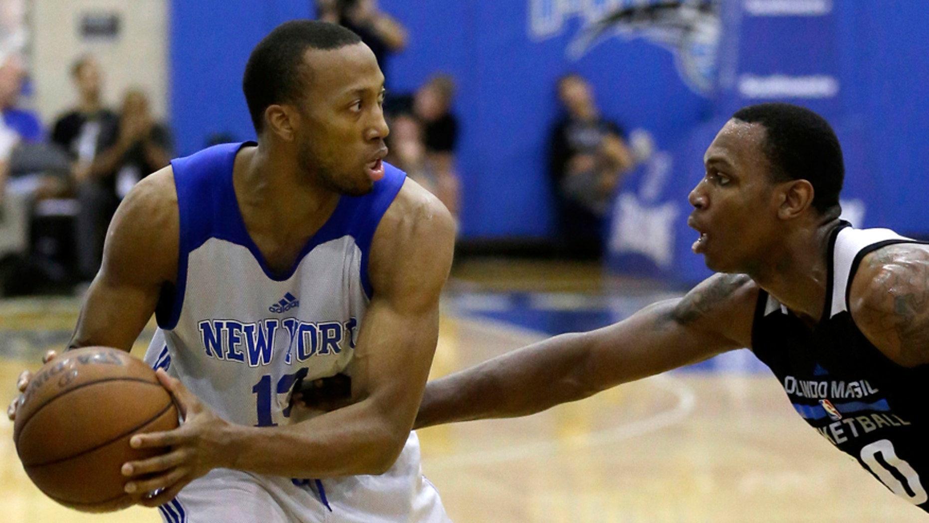 FILE - This is a Wednesday, July 6, 2016 file photo of New York Knicks' Akil Mitchell, left, as he looks to pass the ball around Orlando Magic White's Treveon Graham during the first half of an NBA summer league basketball game in Orlando, Fla. American basketball player Akil Mitchell's eye popped out of its socket after he was poked in the face while going for a rebound during a game in New Zealand Thursday Jan. 26, 2017 .(AP Photo/John Raoux, File)