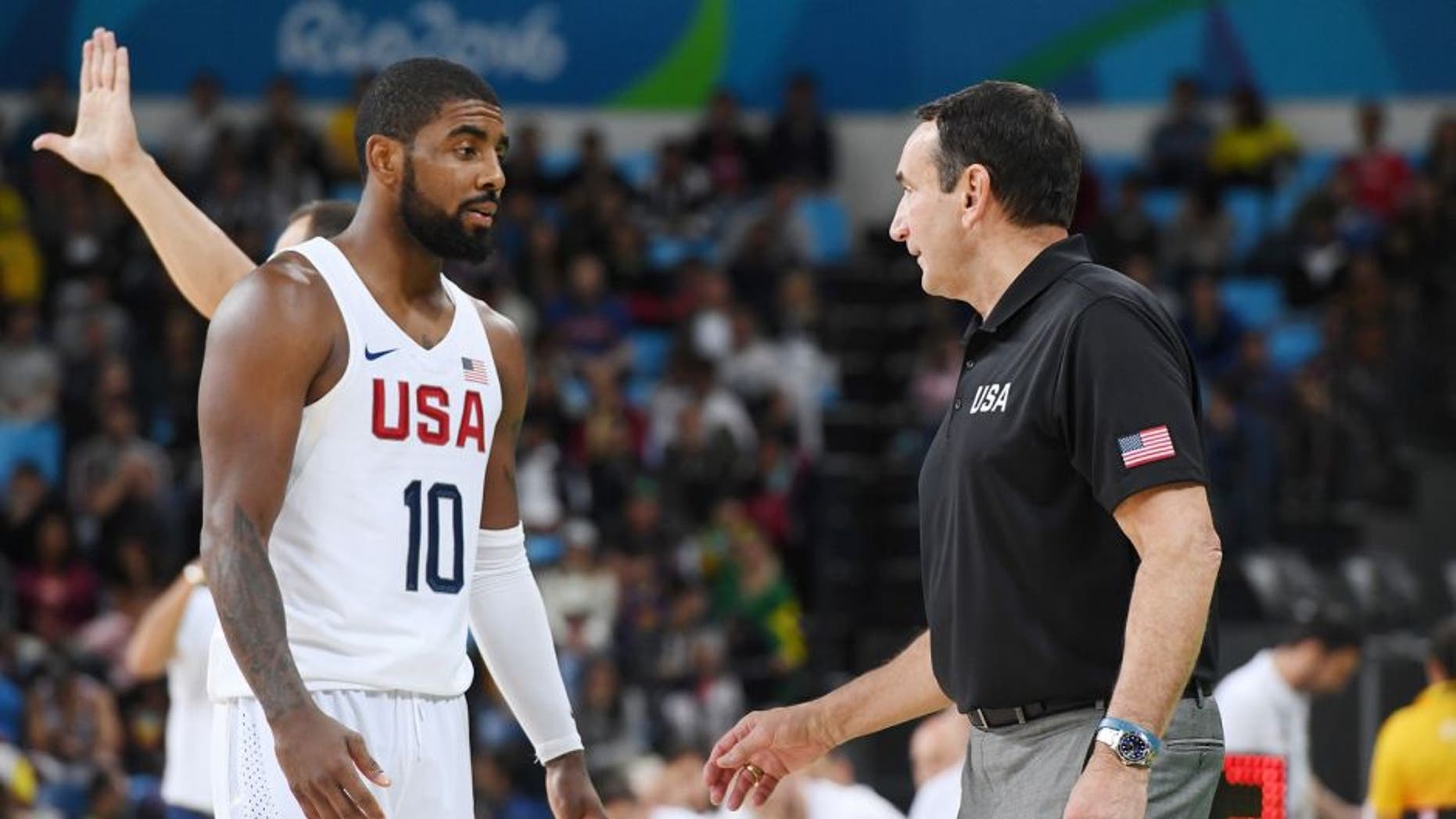 RIO DE JANEIRO, BRAZIL - AUGUST 12: Kyrie Irving #10 and head coach Mike Krzyzewski of the USA Basketball Men's National Team talk during the game against Serbia on Day 7 of the Rio 2016 Olympic Games at Carioca Arena 1 on August 12, 2016 in Rio de Janeiro, Brazil. NOTE TO USER: User expressly acknowledges and agrees that, by downloading and/or using this Photograph, user is consenting to the terms and conditions of the Getty Images License Agreement. Mandatory Copyright Notice: Copyright 2016 NBAE (Photo by Garrett Ellwood/NBAE via Getty Images)