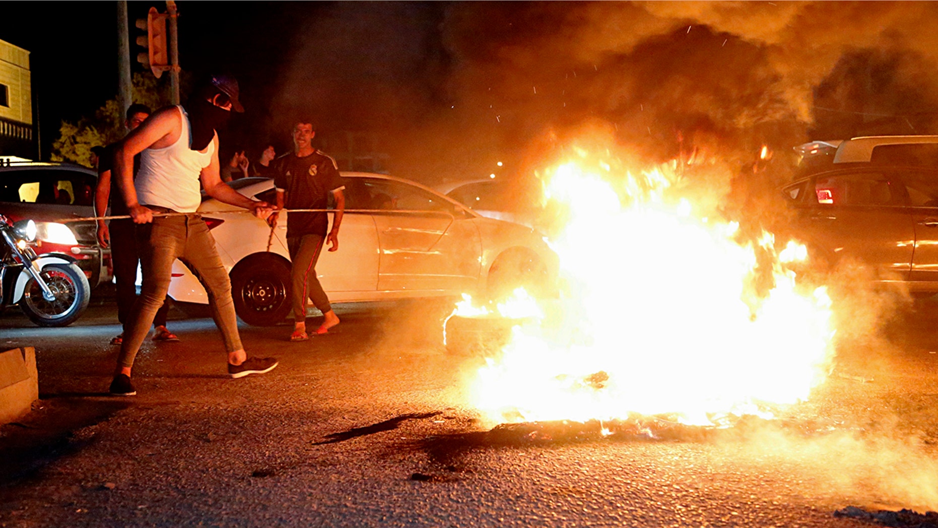 Iraqi protesters demanding services and jobs burn tires during a demonstration in Basra, 340 miles southeast of Baghdad, Iraq, July 13, 2018.