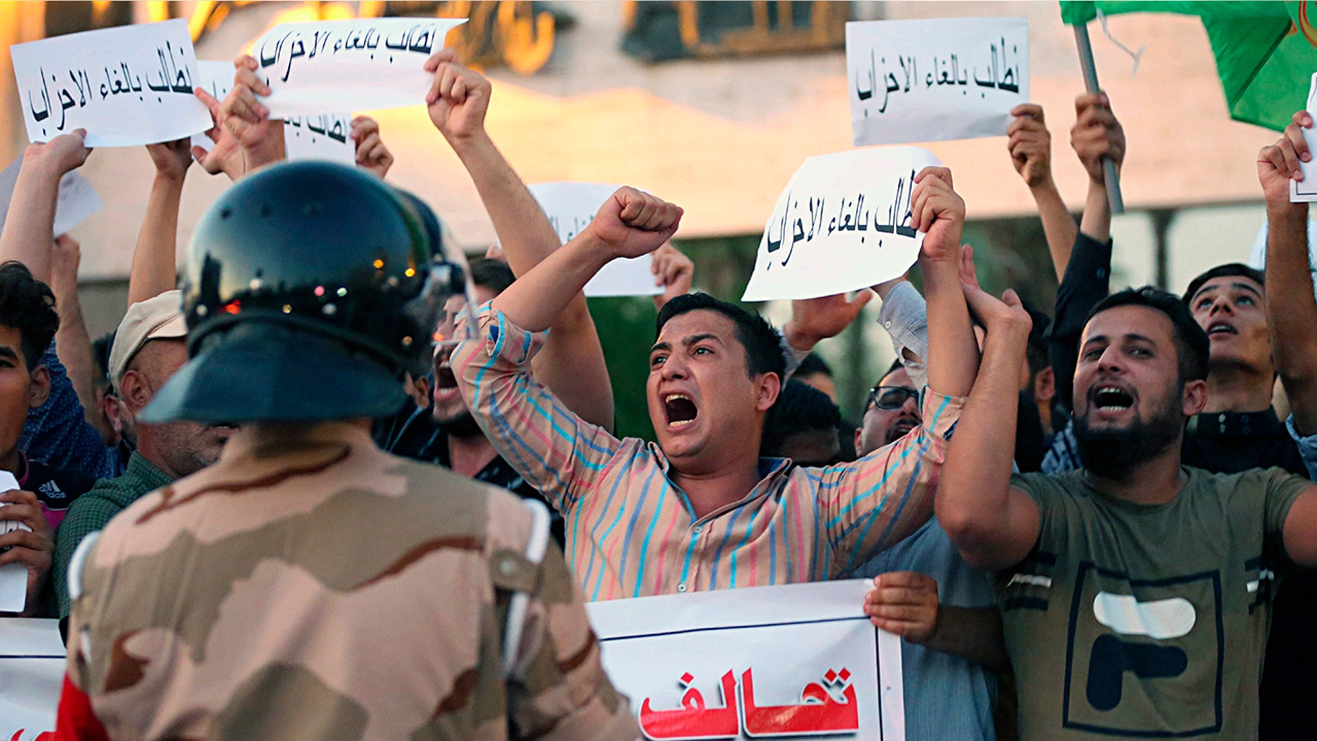 Iraqi protesters chant slogans demanding services and jobs during a demonstration in Tahrir Square, Baghdad, Iraq, July 14.