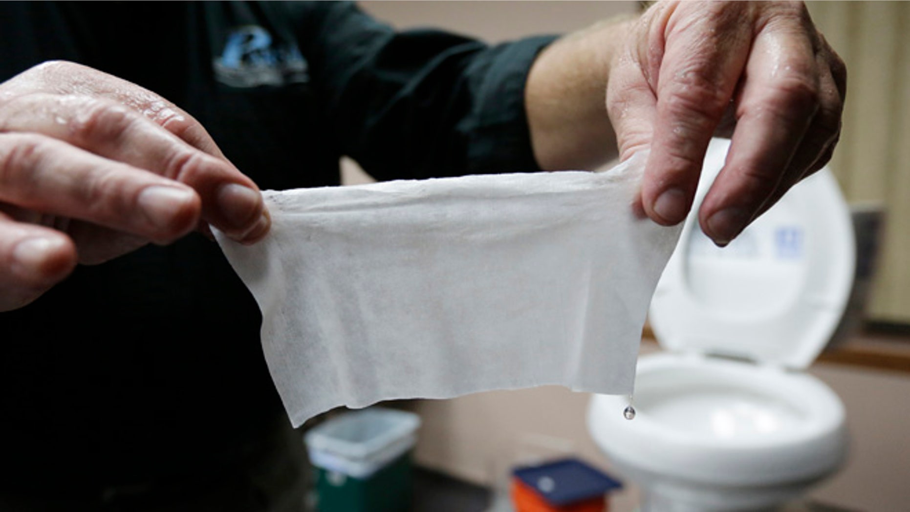 Sept. 20, 2013: In this photograph taken in Middlesex, N.J., Rob Villee, executive director of the Plainfield Area Regional Sewer Authority in New Jersey, holds up a wipe he flushed through his test toilet in his office. Increasingly popular bathroom wipes, thick, premoistened towelettes that are advertised as flushable, are creating clogs and backups in sewer systems around the nation.
