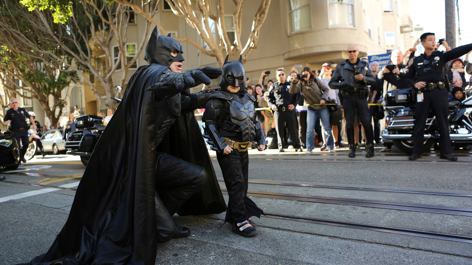 November 15, 2013. Five-year-old leukemia survivor Miles Scott, dressed as Batkid arrives with Batman to rescue a woman in distress as part of a day arranged by the Make- A - Wish Foundation in San Francisco, California. The young cancer survivor will be treated to various super hero scenarios including receiving a commendation at San Francisco City Hall.
