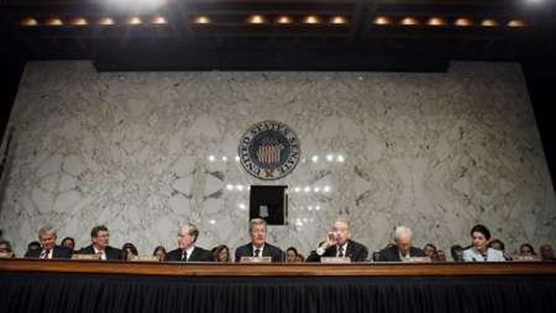 Sen. Max Baucus, center, chairman of the Senate Finance Committee, speaks alongside other panel members before a health care vote in Washington Oct. 13. (Reuters Photo)