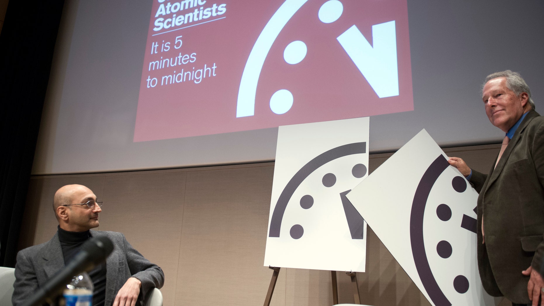 FILE- In this Jan. 22, 2015, file photo, Climate scientist Richard Somerville, member, Science and Security Board, Bulletin of the Atomic Scientists, right, unveils the new "Doomsday Clock," accompanied by Sivan Kartha, member, Science and Security Board, Bulletin of the Atomic Scientists and senior scientist at the Stockholm Environmental Institute. (AP Photo/Cliff Owen, File)