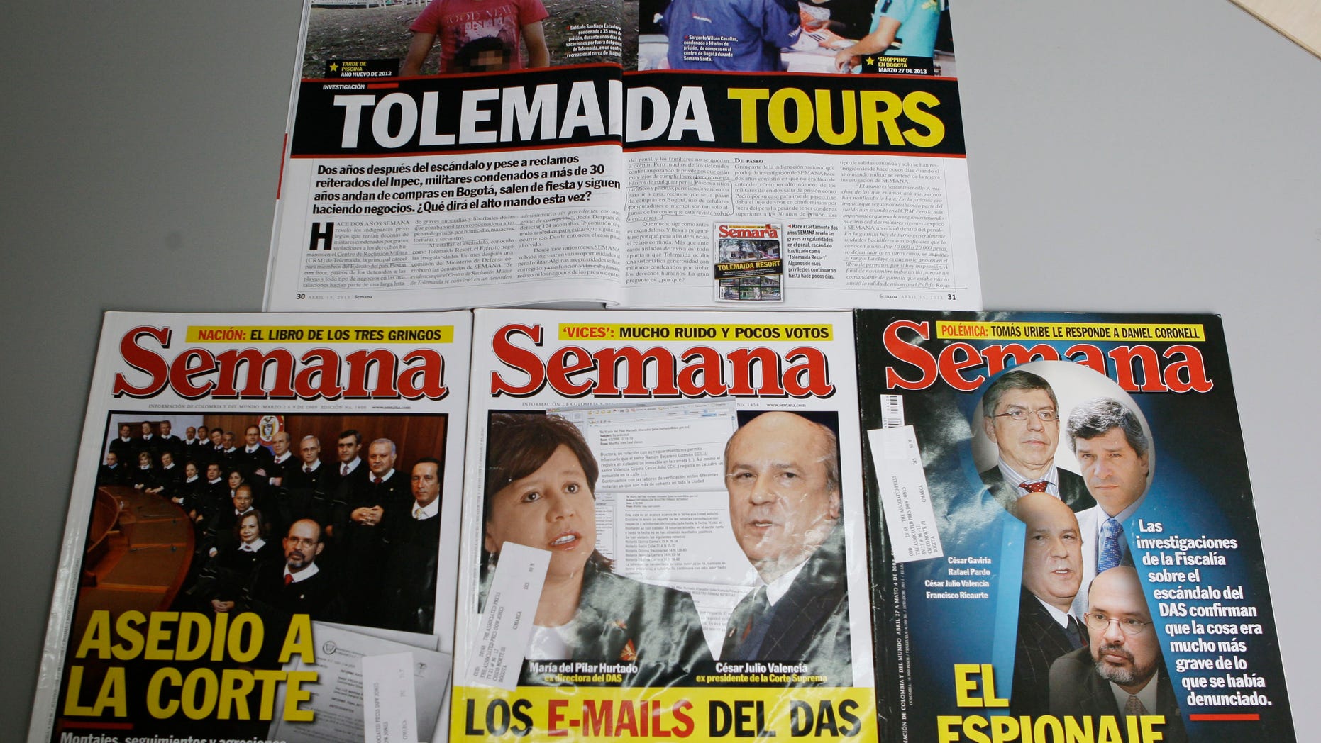 This Thursday, May 9, 2013 photo, shows issues of Semana magazine featuring investigative reports written by journalist Ricardo Calderon, in Bogota, Colombia. Calderon's most recent investigative series for Semana magazine exposed the scandalously luxurious life of military officers jailed for crimes including murder and genocide at Tolemaida army base. (AP Photo/Ricardo Mazalan)