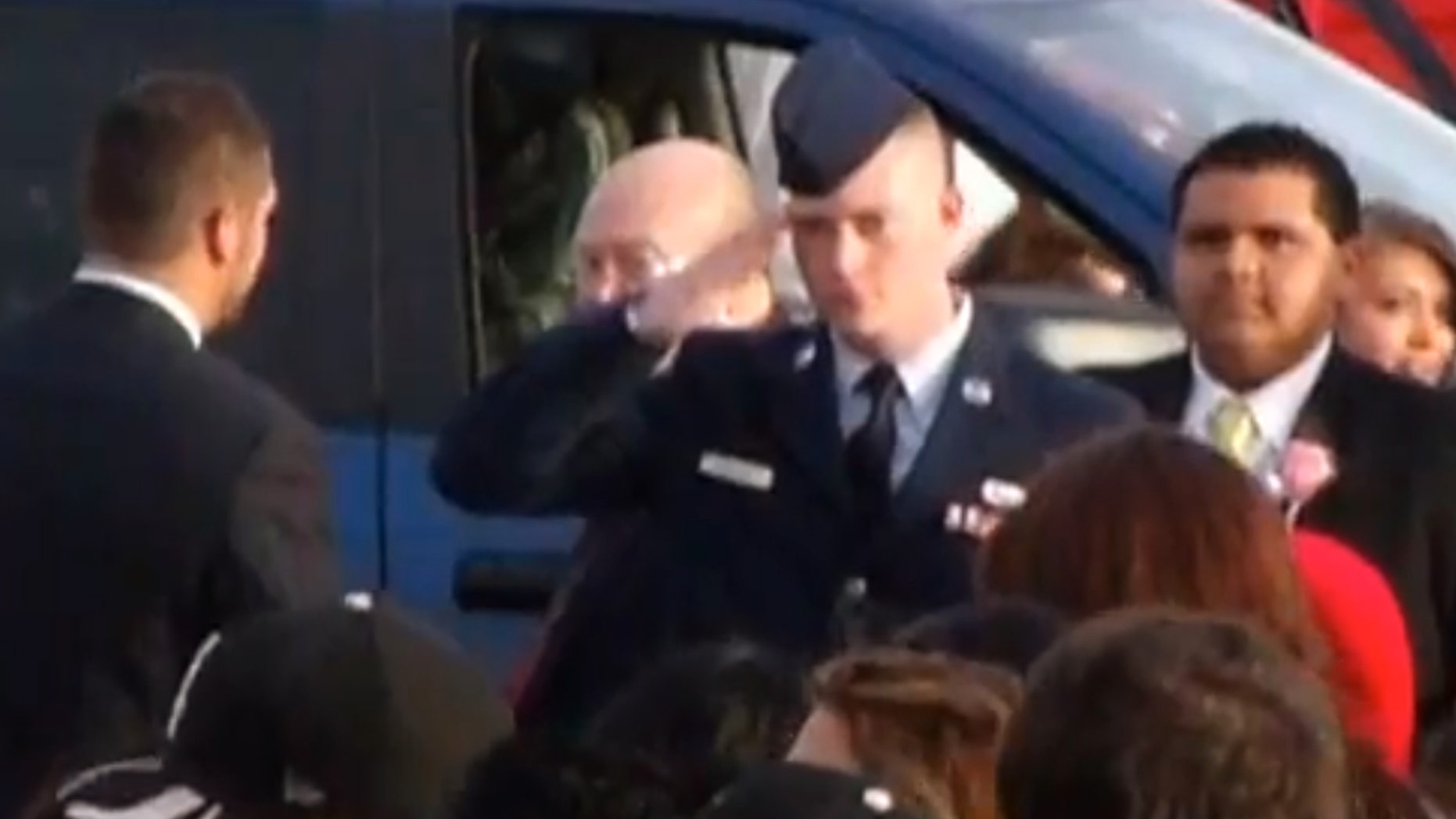 In this still image taken from an April 20, 2013 video provided by Tammy Garth, Airman Cassey Widener salutes as his sister, Courtrney Widener, arrives for prom at Liberal High School in Liberal, Kan. Courtney wanted her brother, recently returned from Afghanistan, to escort her to front door of the school, but school officials denied her request stating that at 22, he was too old to participate. The high school principal that barred Airman Cassey Widener from escorting his sister to prom has apologized, saying the intent was not to dishonor him. Deputy Superintendent Paul Larkin said Tuesday, April 30, 2013 that a policy change allowing exceptions to the age restriction will be presented at Monday’s school board meeting. (AP Photo/Tammy Garth)