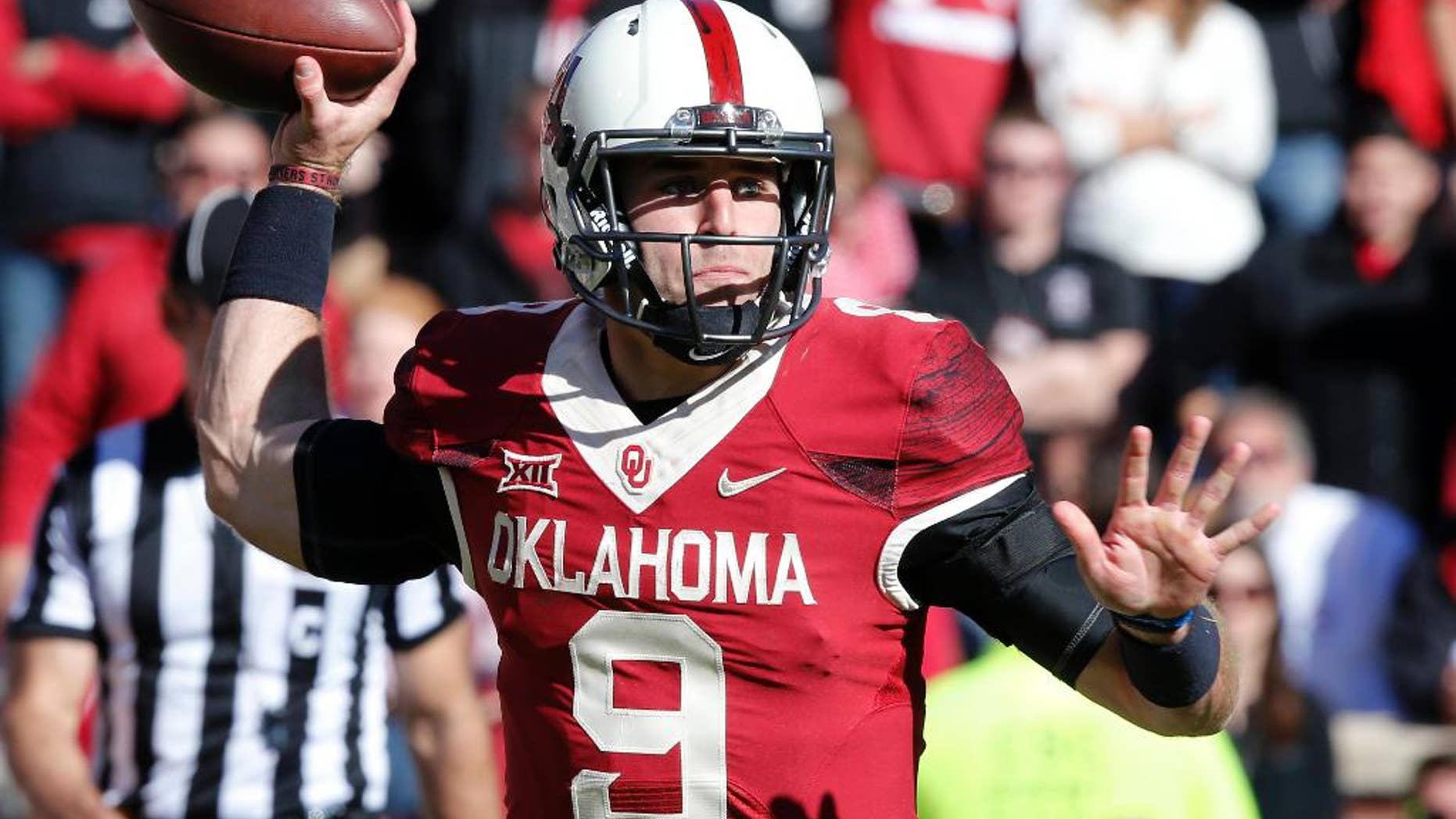 Oklahoma quarterback Trevor Knight (9) passes in the third quarter of an NCAA college football game against Baylor in Norman, Okla., Saturday, Nov. 8, 2014. Baylor won 48-14. (AP Photo/Sue Ogrocki)