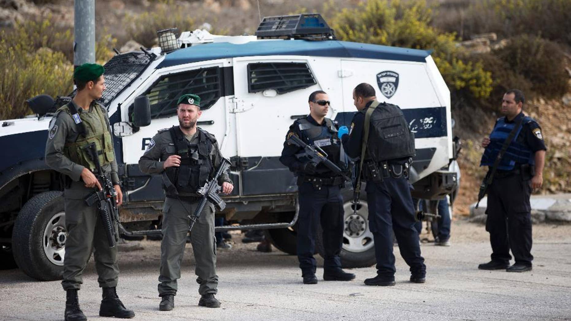 Israeli border police officers secure a checkpoint near the West Bank town of Nablus, Friday, Oct. 30, 2015. (AP Photo/Ariel Schalit)