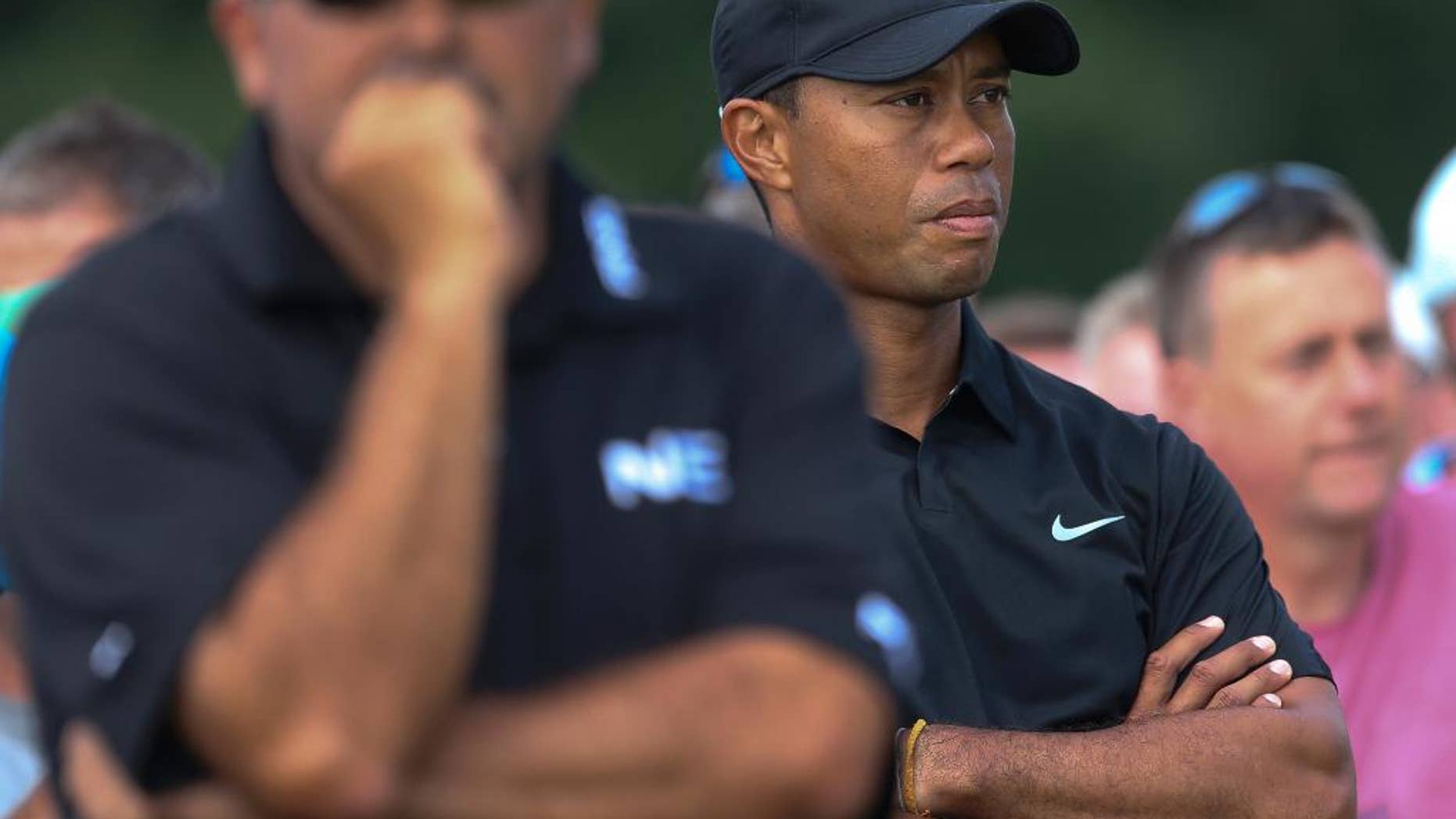 Tiger Woods of the US, right, and Angel Cabrera of Argentina wait to play on the 10th tee box during the second day of the British Open Golf championship at the Royal Liverpool golf club, Hoylake, England, Friday July 18, 2014. (AP Photo/Peter Morrison)