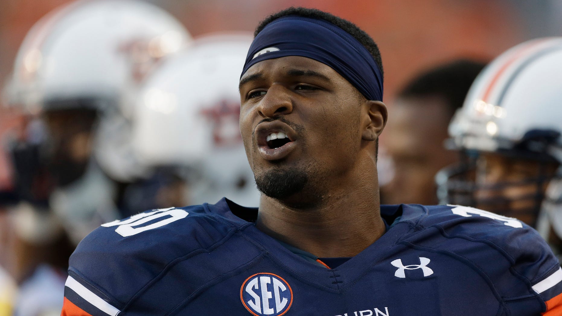 In this photo taken Sept. 14, 2013, Auburn defensive end Dee Ford (30) watches from the sidelines in the first half of an NCAA college football game against Mississippi State in Auburn, Ala. Dee Ford has visions of another surprising national title run. Even if that proves a stretch, the 11th-ranked Tigers have risen from a dreadful season to the brink of the Top 10 with an about-face that's come with the rapidity of the next play in Gus Malzahn's no-huddle offense. Ford's ambition goes beyond that. Way beyond. "I think we can win it all. You know?" he said. "There's no reason to say that we can't. We said we wanted to have the biggest turnaround in college football. Why not win it all? (AP Photo/Dave Martin)