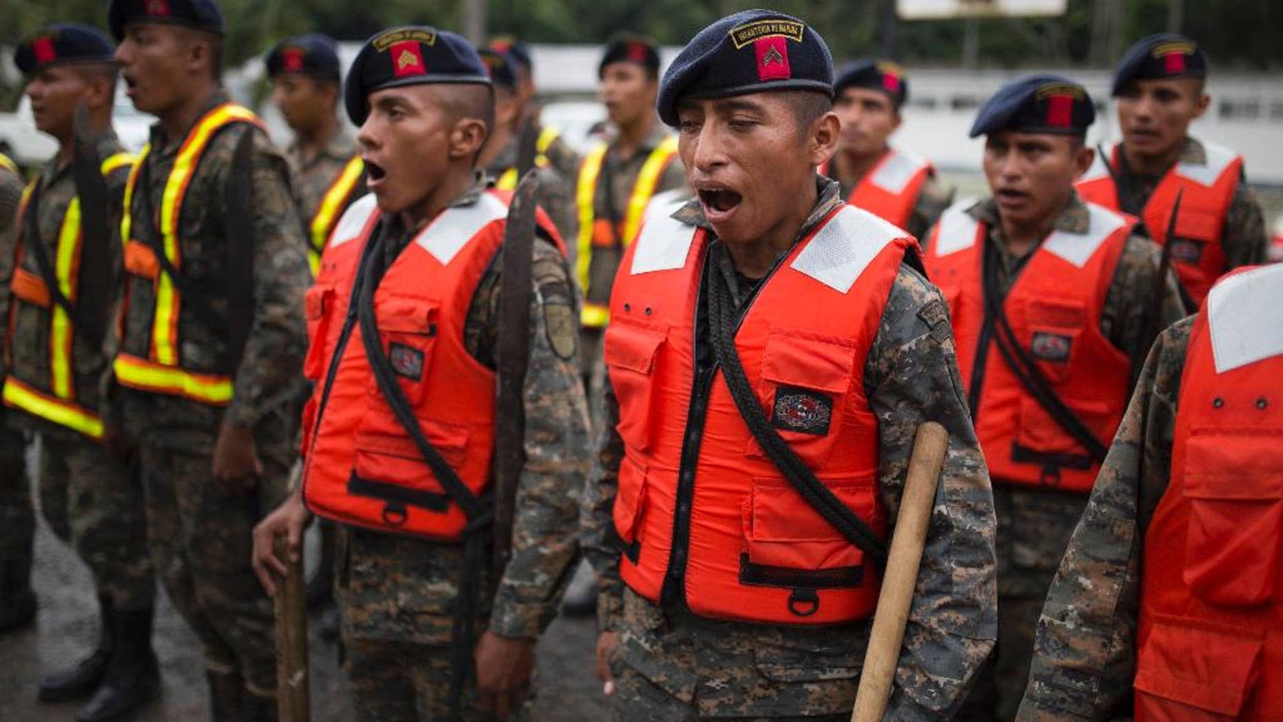 Guatemalan army soldiers sing as they stand for review at their base, before the arrival of Hurricane Earl in Puerto Barrios, Guatemala, Tuesday, Aug. 3, 2016. Hurricane Earl bore down on the coast of the Caribbean nation of Belize with the danger of high surf and winds, while also threatening neighboring Guatemala and southern Mexico with torrential rains. (AP Photo/Luis Soto)