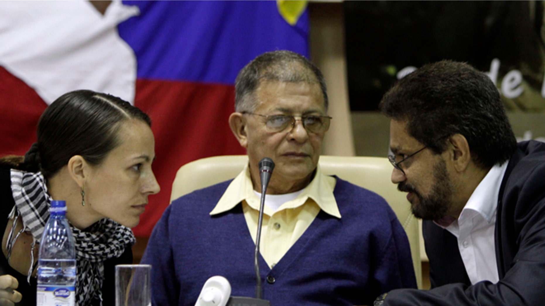 Ivan Marquez, right, chief negotiator for Colombia's Revolutionary Armed Forces of Colombia, or FARC, speaks with Dutch rebel Tanja Nijmeijer as Ricardo Tellez looks on during a press conference in Havana, Cuba, Thursday, Nov. 29, 2012. After days of intensive peace talks between the FARC and the Colombian government, negotiators will recess and resume talks on Dec. 5. (AP Photo/Franklin Reyes)
