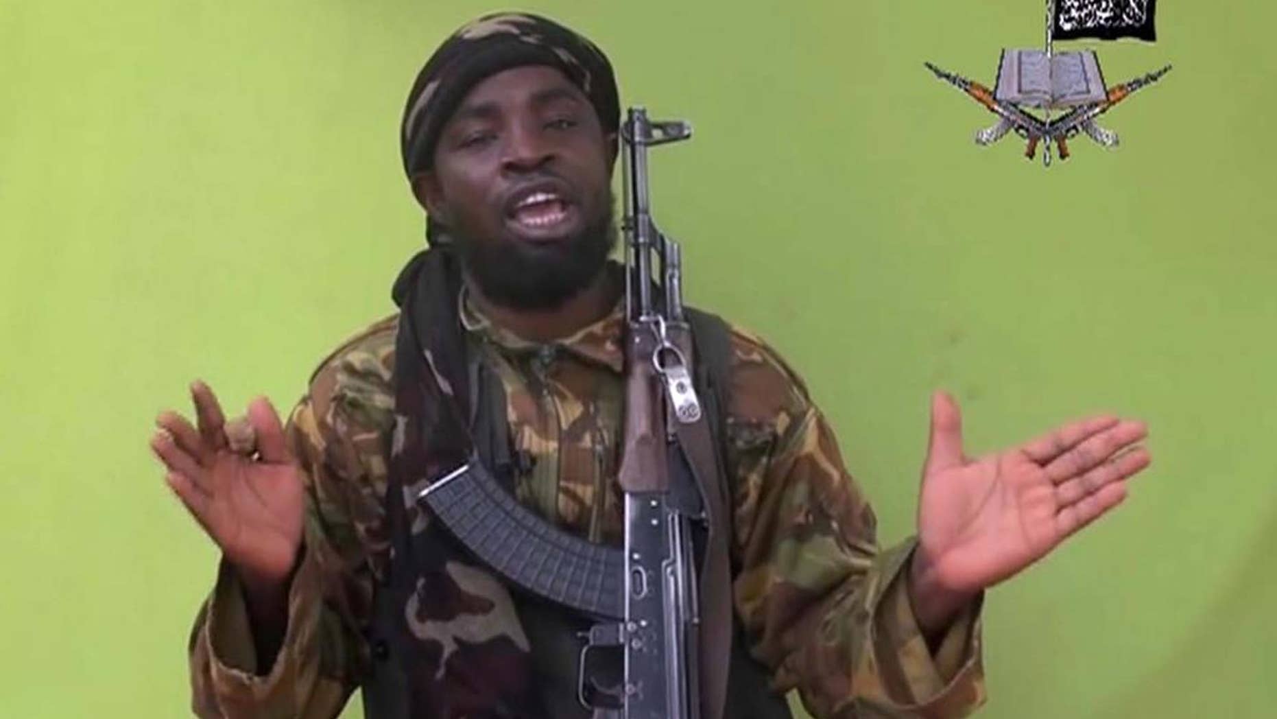 FILE - This is a Monday May 12, 2014 file photo taken from video by Nigeria's Boko Haram terrorist network, and shows their leader Abubakar Shekau speaking to the camera. Suspected Boko Haram militants attacked a village on the shore of Lake Chad early Friday Feb. 13, 2015 marking the first such violence against the neighbor contributing the most military might to the regional fight against the Nigeria-based terror group. (AP Photo/File)