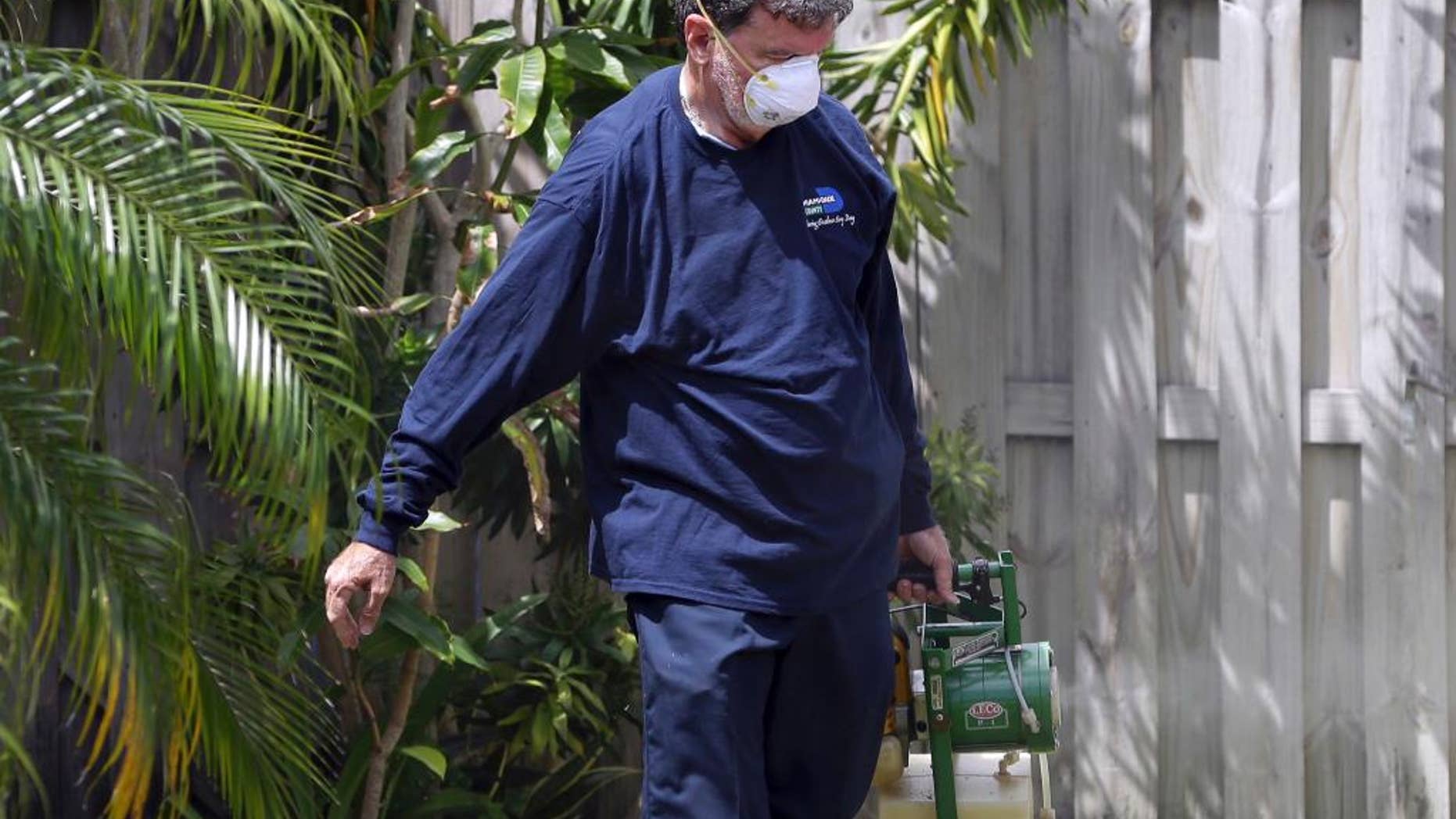 FILE - In this April 12, 2016 photo, Giraldo Carratala, an inspector with the Miami- Dade County, Fla. mosquito control unit, sprays pesticide in the yard of a home in Miami, Fla. On Tuesday, June 14, 2016, health officials announced a plan to combat Zika that includes a special team of experts that can be dispatched to states if the virus spreads in the U.S. Officials aren't expecting big outbreaks of the mosquito-borne virus like in Latin America and the Caribbean. But they do think some U.S. cases are likely as the mosquito season heats up. (AP Photo/Lynne Sladky)