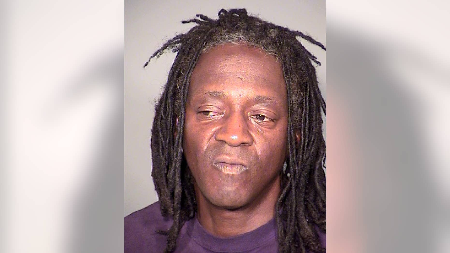 This undated booking photo provided by the Clark County Detention Center shows William Drayton Jr. aka Flavor Flav after his arrest in Las Vegas. Authorities say they arrested the entertainer shortly after midnight on Thursday, May 21, 2015, in Las Vegas for driving under the influence, speeding, possessing less than an ounce of marijuana and having an open container of alcohol in the 2005 black BMW he was driving. (Clark County Detention Center via AP)