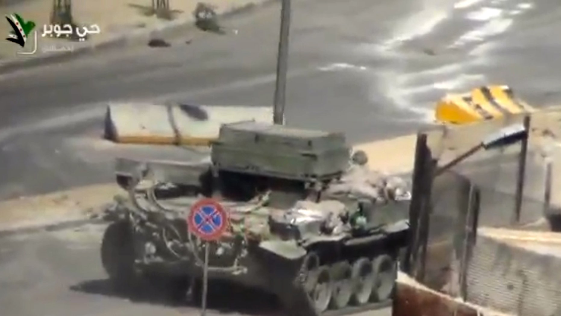 This image taken from video obtained from Ugarit, which has been authenticated based on its contents and other AP reporting, shows a Syrian Army tank in the streets of the Jobar district of Damascus, Syria, Friday, April 26, 2013. On the streets of Damascus, the two-year old conflict dragged on Friday, with government troops pushing into two northern neighborhoods, triggering heavy fighting with rebels as they tried to advance under air and artillery support, activists said. The Britain-based Syrian Observatory for Human Rights said the fighting between rebels and soldiers backed by pro-government militiamen was concentrated in the Jobar and Barzeh areas.(AP Photo/Ugarit via AP video)