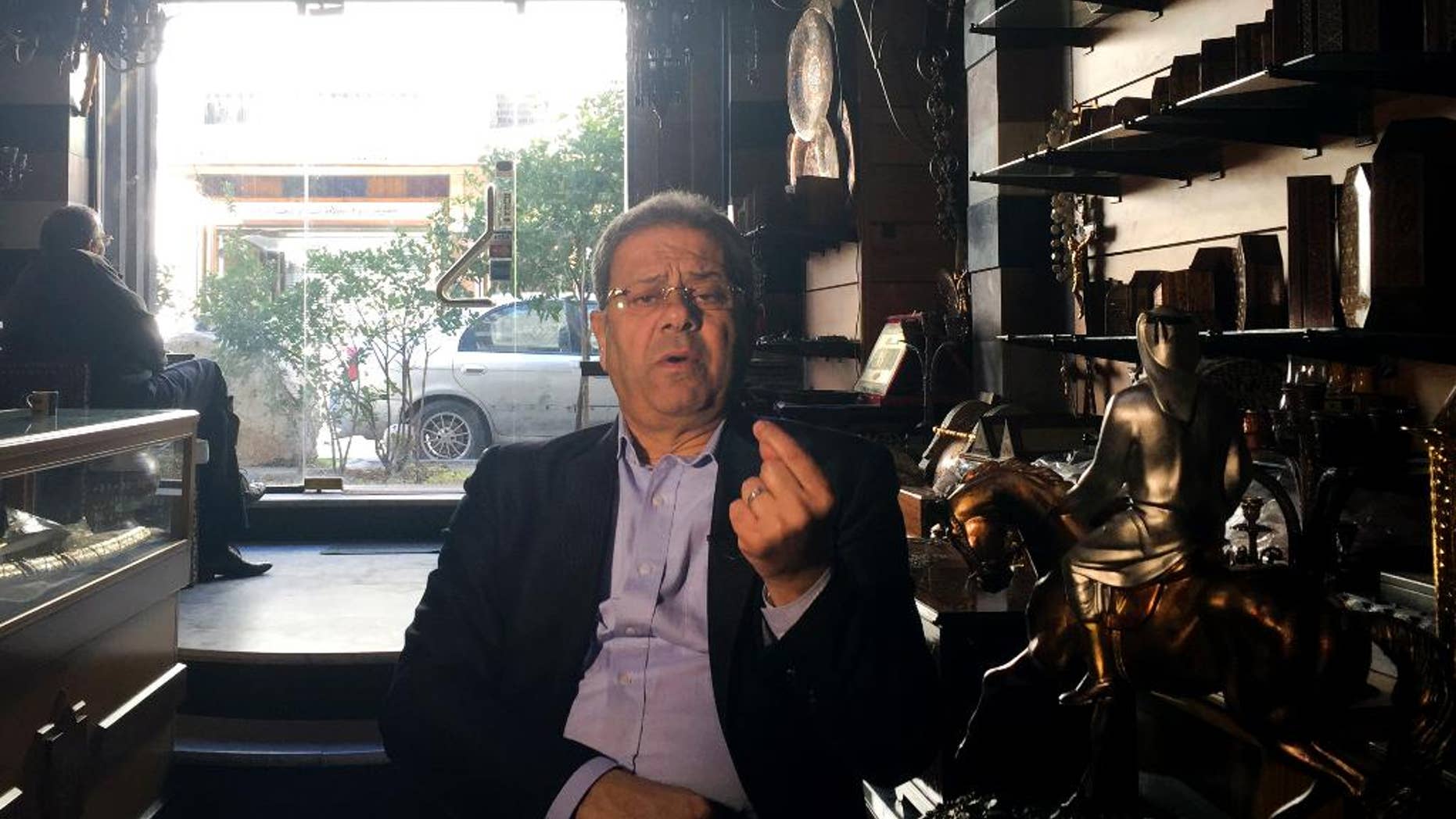 Bassam Abu Assali, who was detained with his family upon arrival in Philadelphia, Pennsylvania, and was forced to board a plane back home to Syria because of U.S. President Trump's executive order, speaks during an interview with The Associated Press at his shop, in Damascus, Syria, Wednesday, Feb. 1, 2017. Assali was turned back over the weekend despite having an immigration visa. He said he would never have made the journey if he knew he would be humiliated this way. He added he would still like to live in the United States if he is allowed and that he believes “America has democracy, freedoms and human rights” despite what happened. (AP Photo)