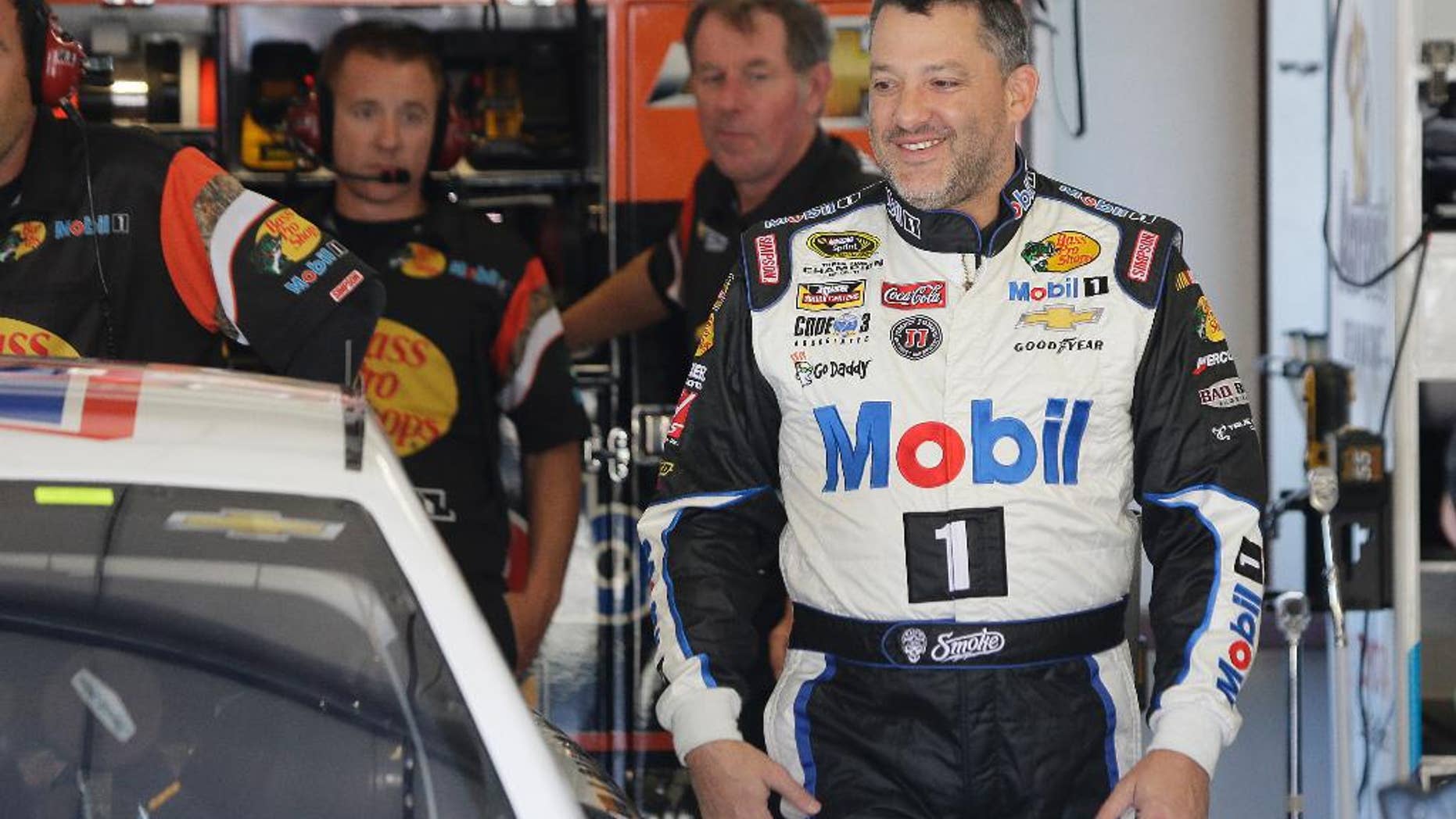 Tony Stewart walks to his car during practice for the NASCAR Sprint Cup Series auto race Friday, June 26, 2015, in Sonoma, Calif. (AP Photo/Eric Risberg)
