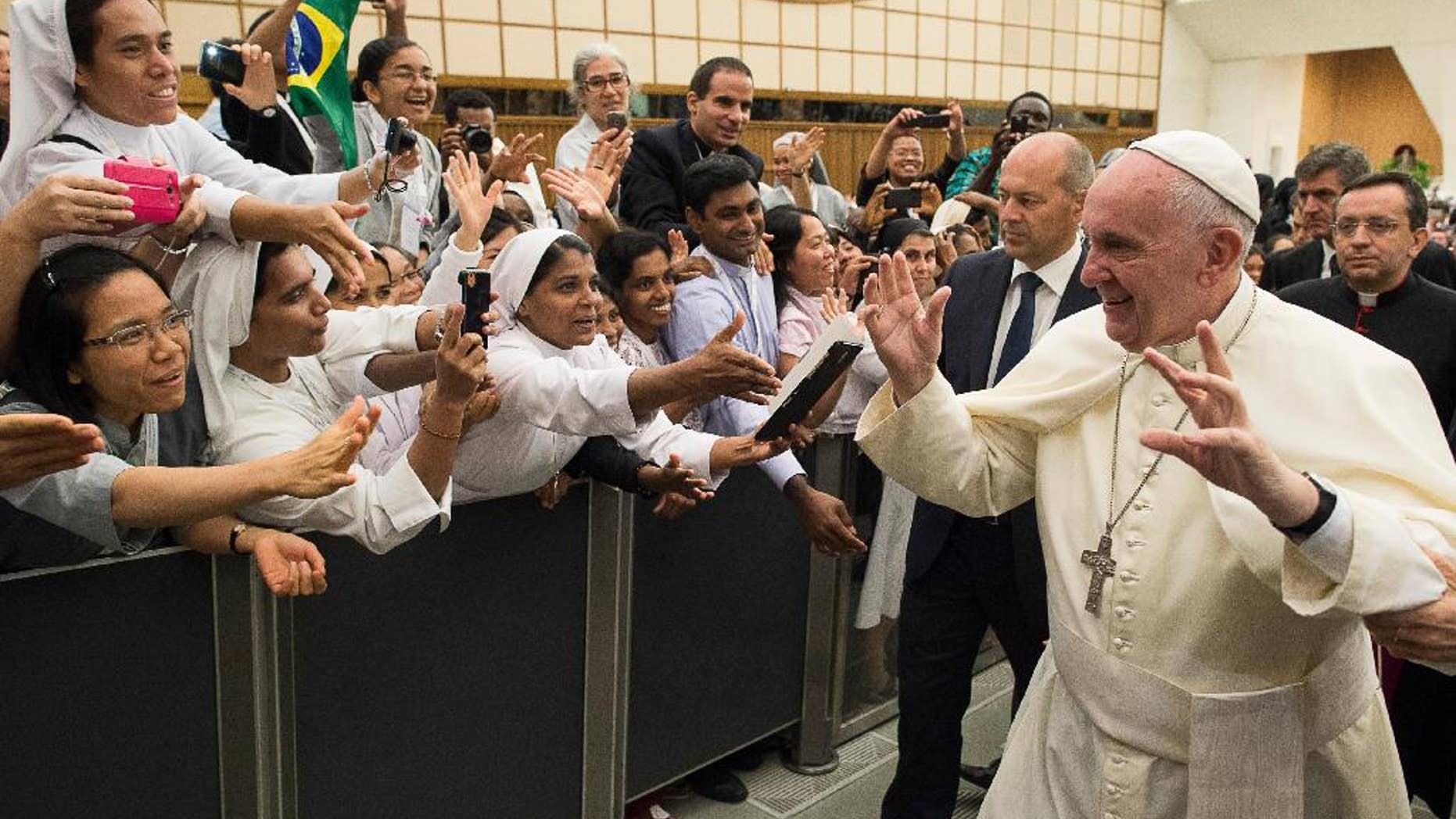 Pope Francis arrives for a meeting wit a group of young people who is participating in the International Congress for Young People in Consecrated Life, taking place in Rome this week, at the Vatican Thursday, Sept. 17, 2015. (L'Osservatore Romano/Pool Photo via AP)