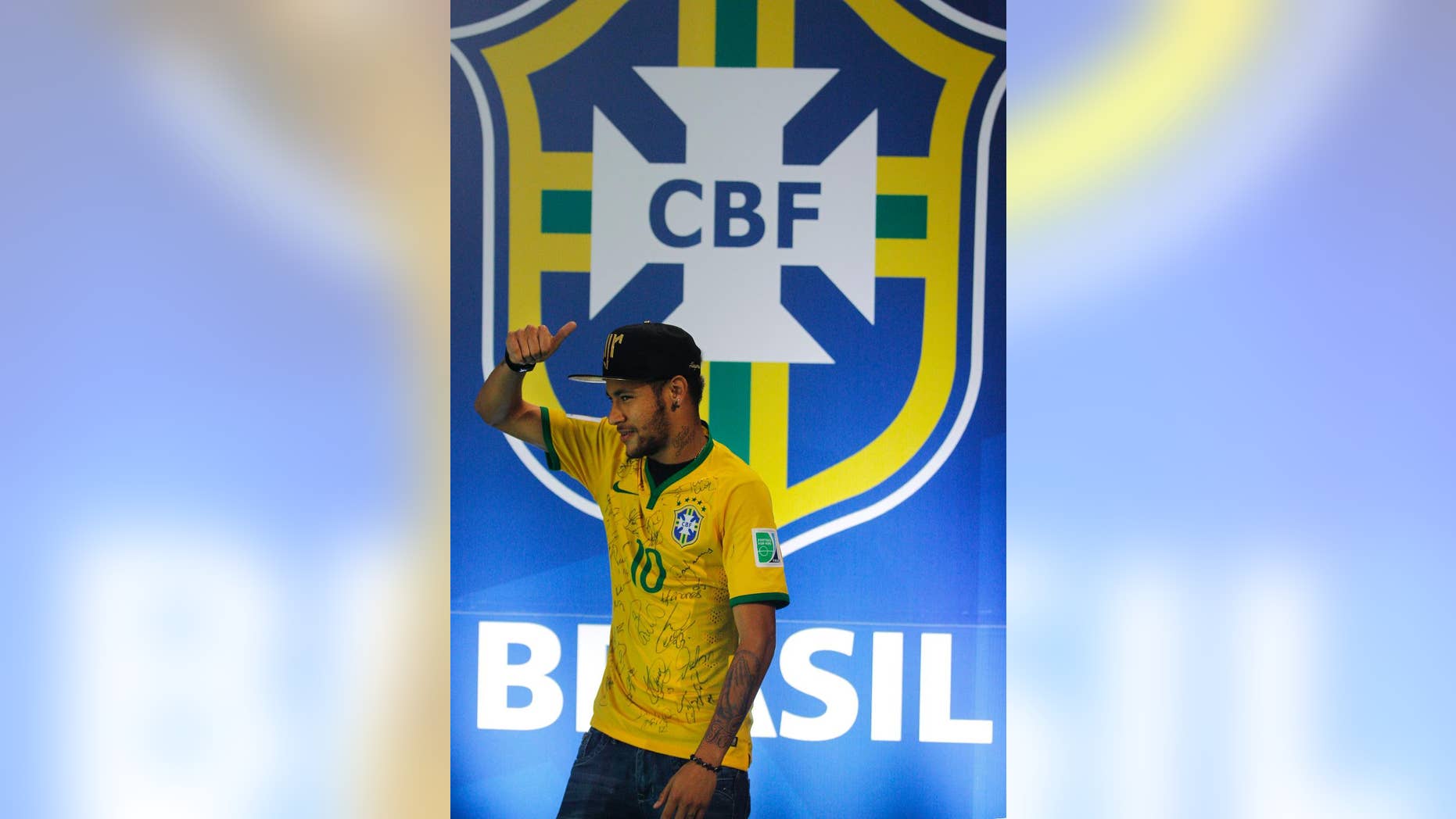 Brazil's Neymar gives the thumbs up, as he leaves after a press conference at the Granja Comary training center in Teresopolis, Brazil, Thursday, July 10, 2014. The Brazilian soccer star is back on his feet after suffering a broken vertebrae during a World Cup soccer match against Colombia. Brazil will be disputing a third place finish, without its star on Saturday. (AP Photo/Leo Correa)