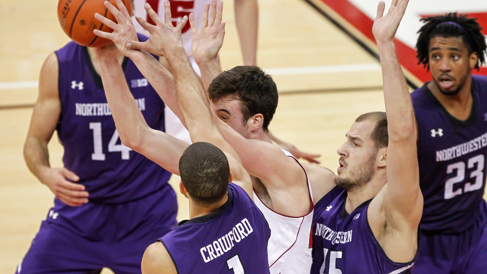 Northwestern's Drew Crawford (1) and Nikola Cerina (45) trap Wisconsin's Frank Kaminsky during the second half of an NCAA college basketball game Wednesday, Jan. 29, 2014, in Madison, Wis. Northwestern upset Wisconsin, 65-56. (AP Photo/Andy Manis)