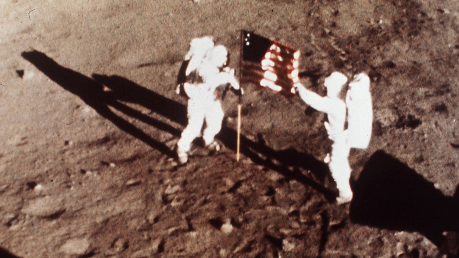 July 20, 1969: Apollo 11 astronauts Neil Armstrong and Edwin E. "Buzz" Aldrin, the first men to land on the moon, plant the U.S. flag on the lunar surface.