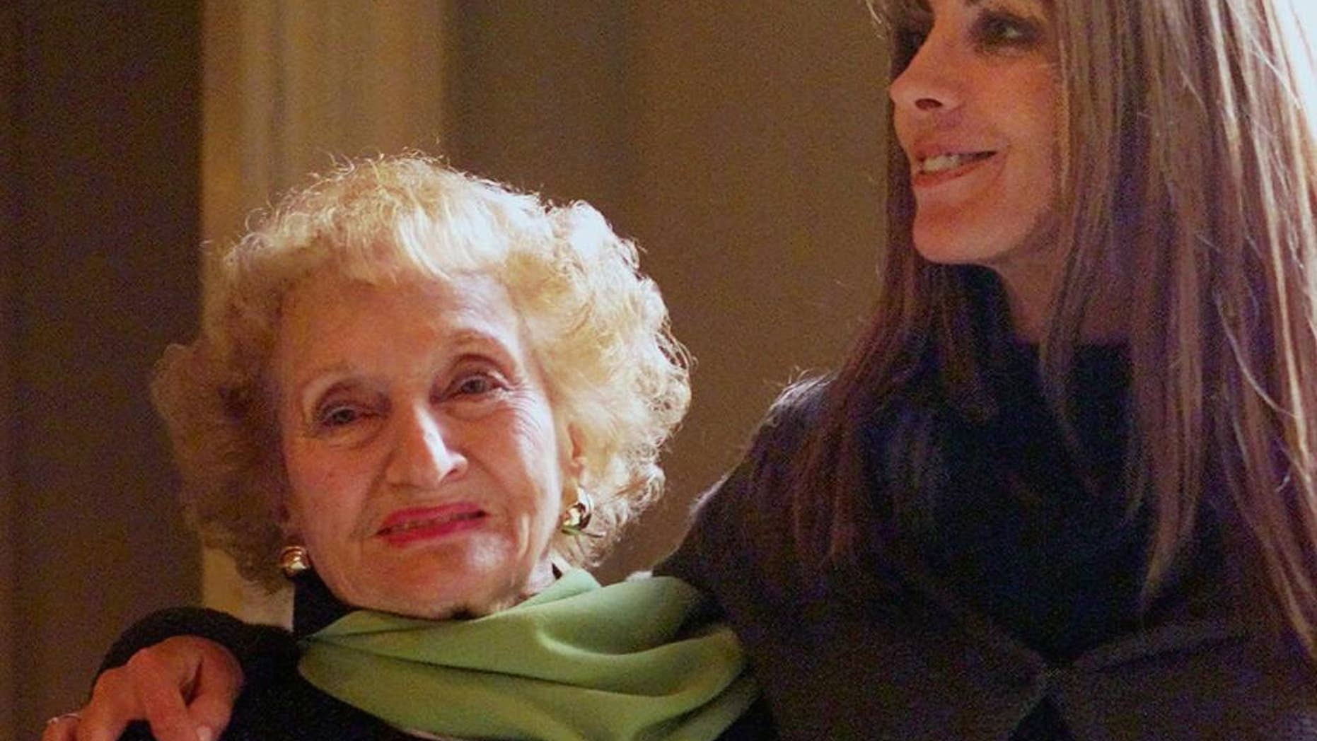 FILE- In this Jan. 9, 2001, file photo, Dr. Ruth Gruber, left, and actress Natasha Richardson pose for a photo at the Ritz Carlton Huntington Hotel in Pasadena, Calif. Gruber, the journalist and humanitarian whose long, trailblazing life included helping to bring Jewish refugees to the United States during World War II, has died. She was 105. Gruber died on Thursday, Nov. 17, 2016, at her home in Manhattan, according to her editor, Philip Turner. (AP Photo/Damian Dovarganes, File)