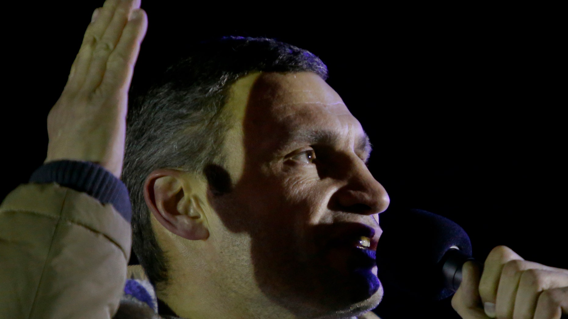 Ukrainian lawmaker and chairman of the Ukrainian opposition party Udar (Punch), WBC heavyweight boxing champion Vitali Klitschko addresses supporters during a rally at the central Independence square in Kiev, Ukraine, on Monday, Dec. 2, 2013. Thousands of protesters besieged government buildings in Ukraine's capital on Monday to demand the ouster of the prime minister and his Cabinet, as anger at the president's decision to ditch a deal for closer ties with the European Union gripped other parts of the country and threatened his rule. (AP Photo/Sergei Grits)