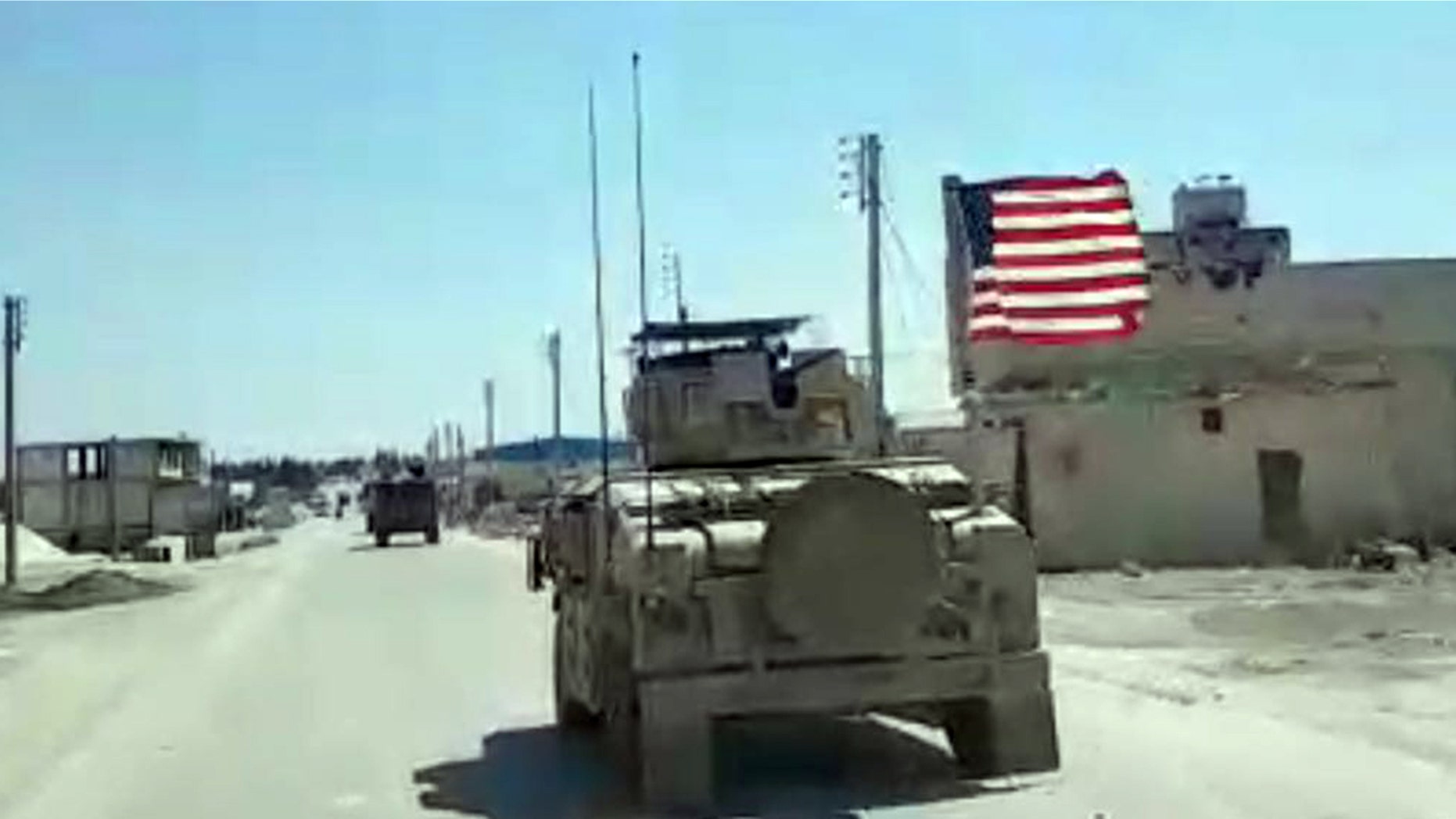 A U.S. humvee rumbles down the street in Manbij, one of the bases of operation for American troops in Syria.