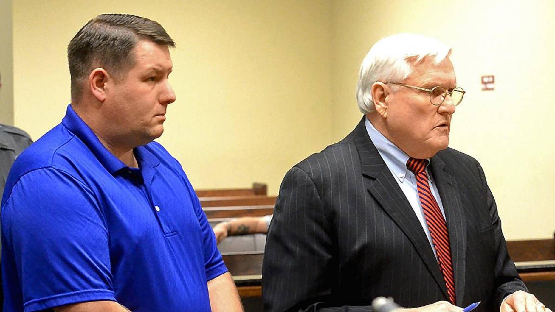 FILE - In a Thursday, Dec. 4, 2014 file photo, Richard Combs, left, the former police chief and sole officer in the small town of Eutawville, S.C., listens in court with his lawyer John O'Leary, in Orangeburg, S.C. Solicitor David Pascoe said in opening arguments Wednesday, Jan. 7, 2015 that Bernard Bailey was murdered over a broken taillight by then-Eutawville Police Chief Combs. But Combs' lawyer O'Leary says the chief had a legitimate warrant against Bailey, and the victim turned his pickup truck into a weapon when he tried to back away as Combs tried to arrest him. (AP Photo/The Times and Democrat, Larry Hardy, File)