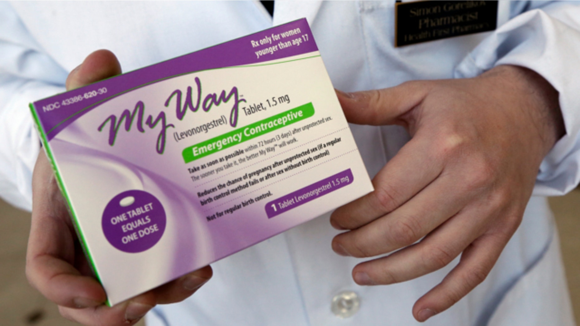 May 2, 2013: Pharmacist Simon Gorelikov holds a generic emergency contraceptive, also called the morning-after pill, at the Health First Pharmacy in Boston.