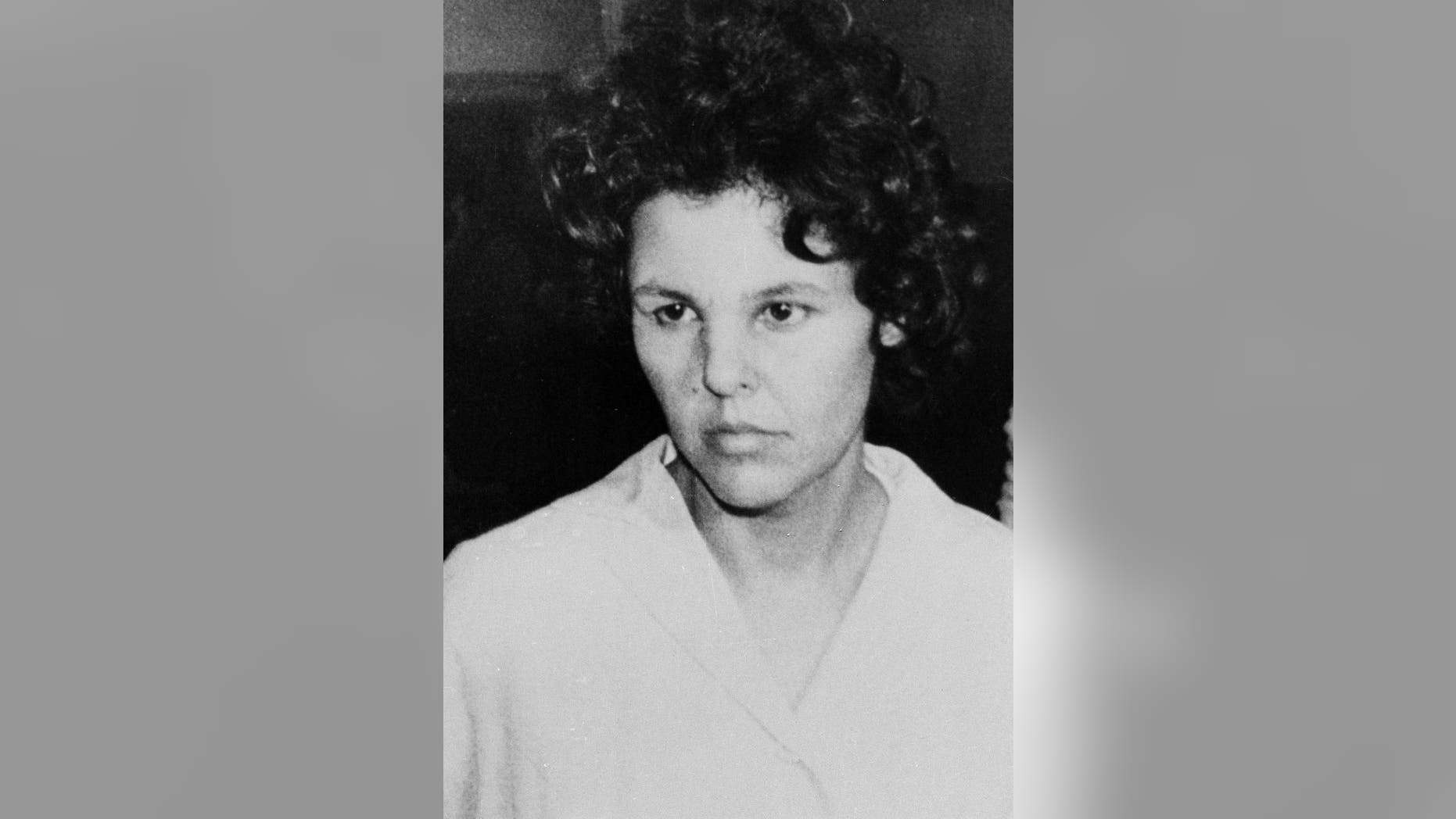 FILE - In this Oct. 21, 1981 file photo, Judith Clark is taken into police custody in Nanuet, N.Y. On Friday, April 21, 2017, New York's Parole Board has denied Clark parole. The former Weather Underground radical drove a getaway car in the1981 Brinks armored car robbery that left three people dead. She has served 35 years of a 75-years-to-life sentence. (AP Photo/David Handschuh, File)