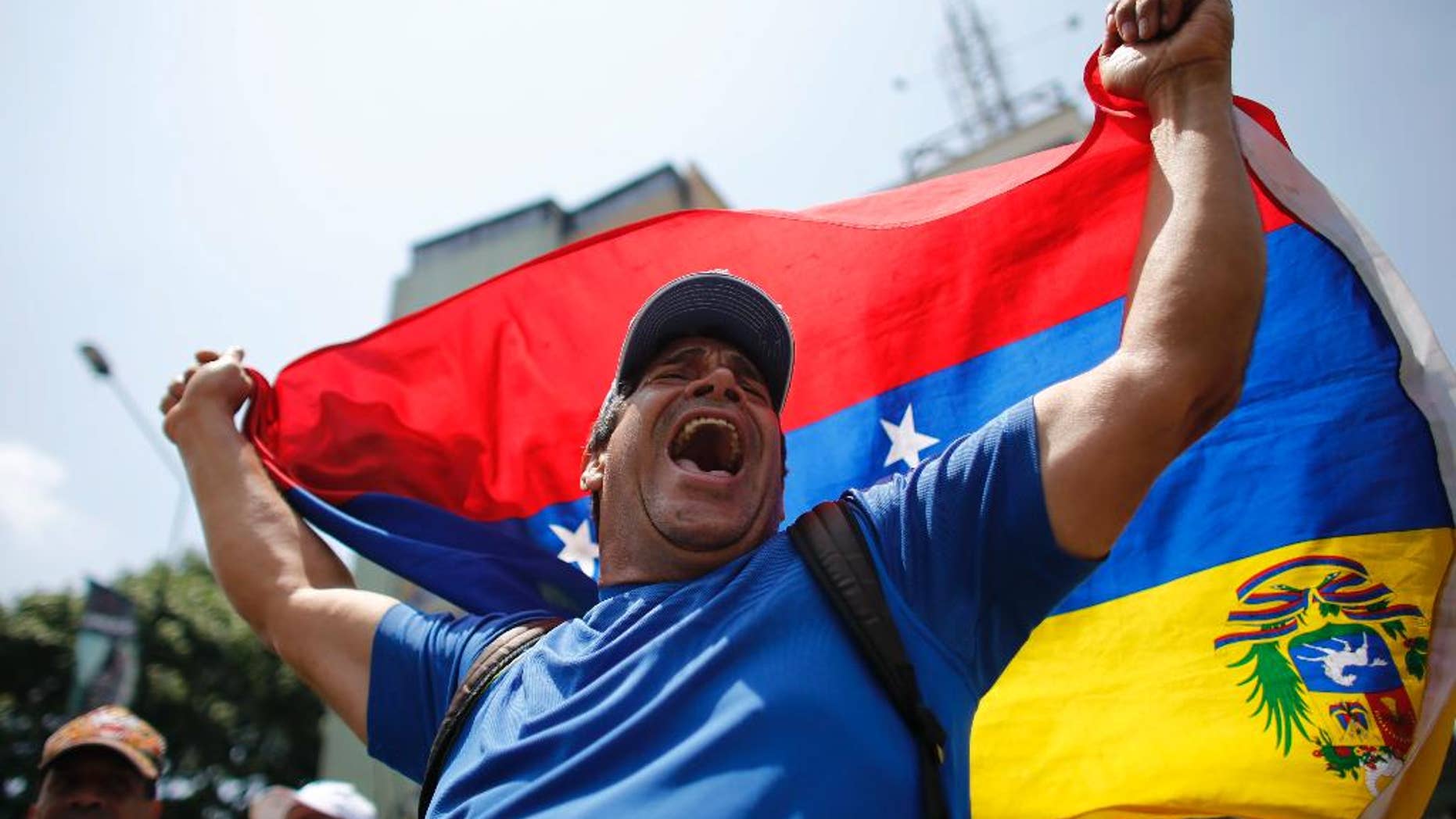 A man shouts anti-government slogans during a protest in Caracas, Venezuela, Thursday, April 20, 2017. Venezuela's opposition is calling for another day of protests against President Maduro after mass demonstrations Wednesday resulted in two deaths. (AP Photo/Ariana Cubillos)