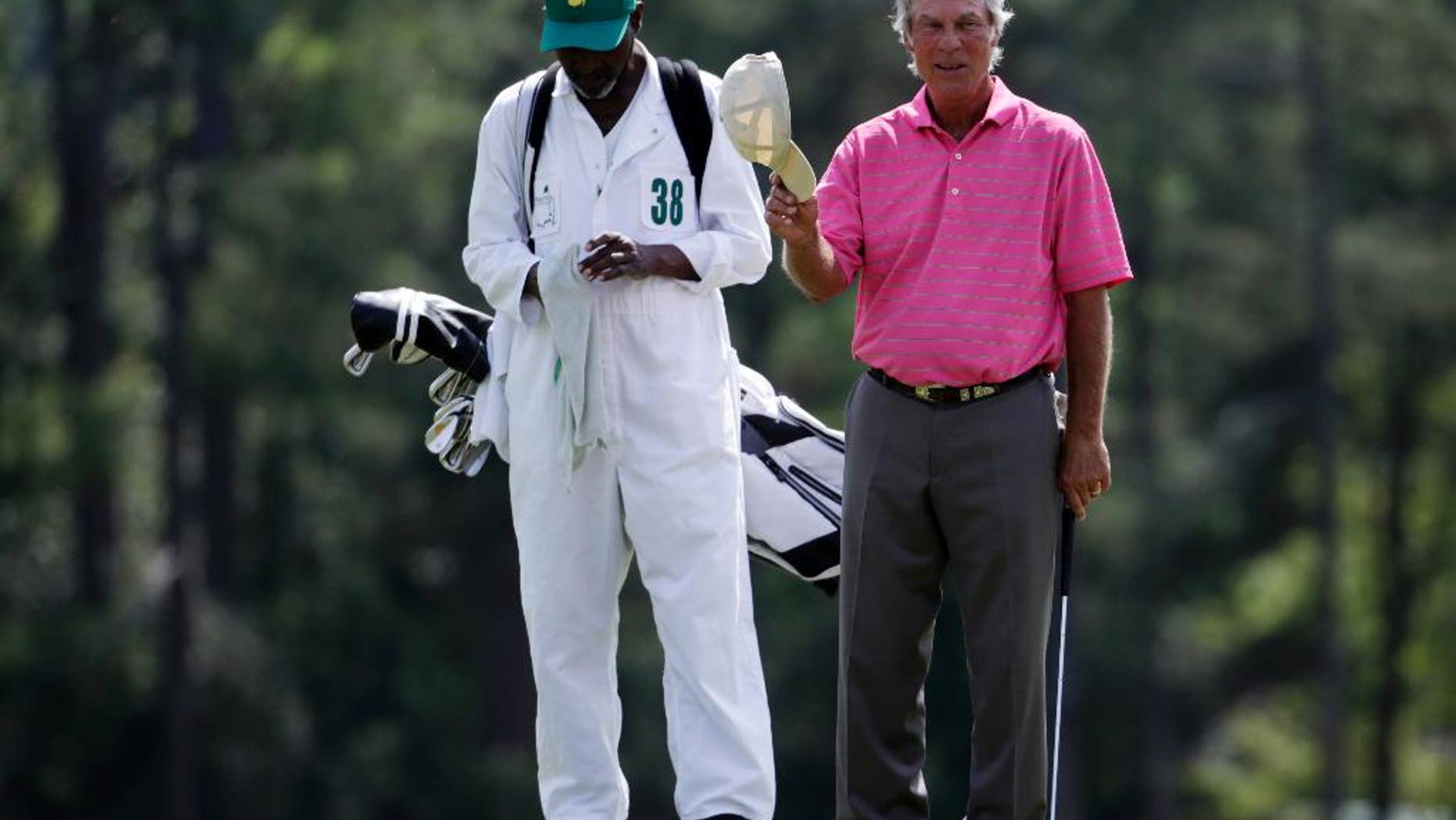 Ben Crenshaw acknowledges applause on the 18th hole during the first round of the Masters golf tournament Thursday, April 9, 2015, in Augusta, Ga. (AP Photo/Darron Cummings)