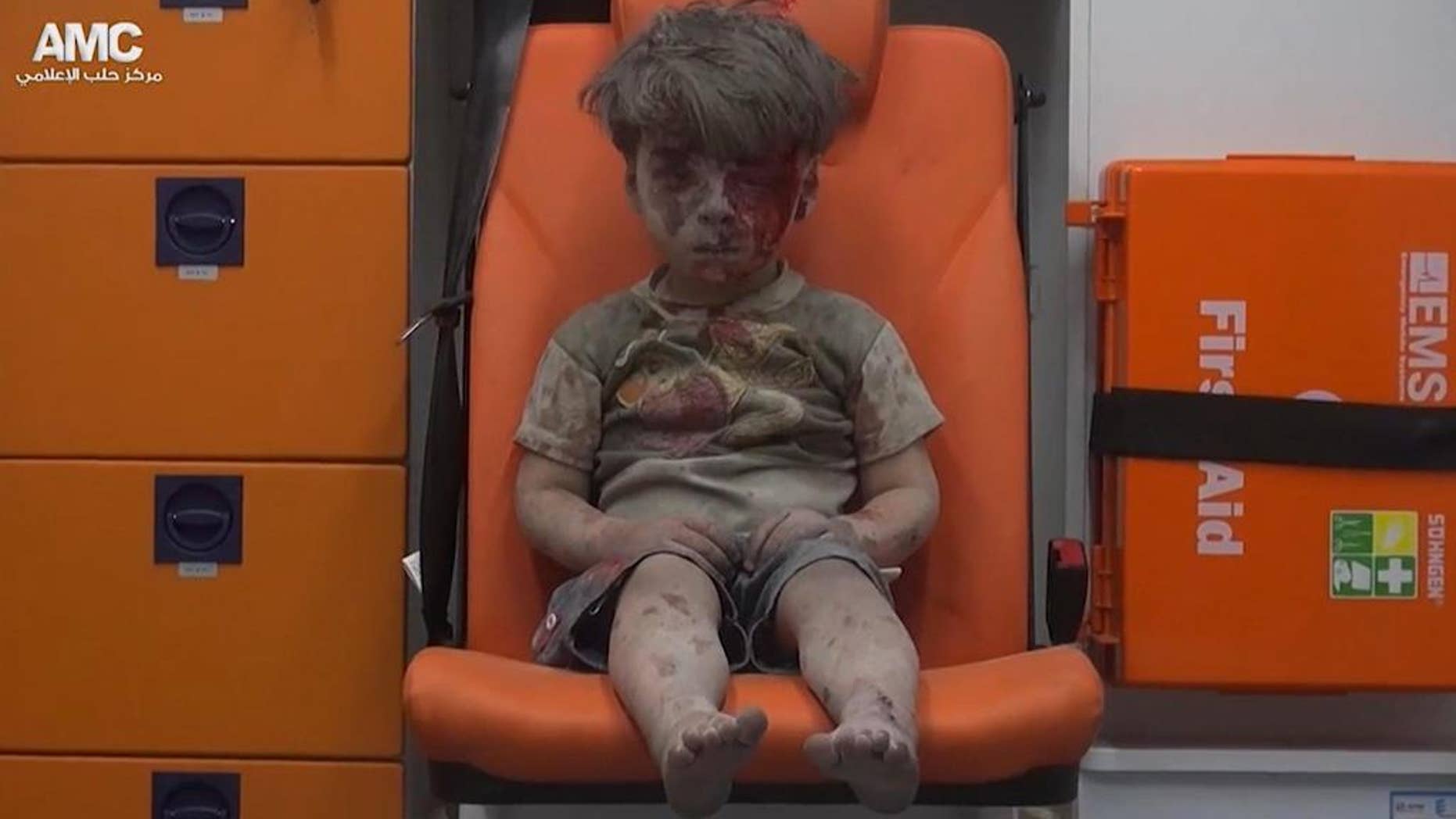 Aug. 17, 2016: In this frame grab taken from video provided by the Syrian anti-government activist group Aleppo Media Center (AMC), a child sits in an ambulance after being pulled out or a building hit by an airstirke, in Aleppo, Syria.