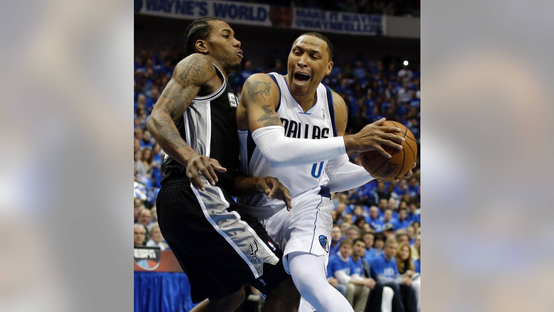 San Antonio Spurs' Kawhi Leonard, left, defends against a drive to the basket by Dallas Mavericks' Shawn Marion, right, in the first half of Game 6 of an NBA basketball first-round playoff series on Friday, May 2, 2014, in Dallas. (AP Photo/Tony Gutierrez)